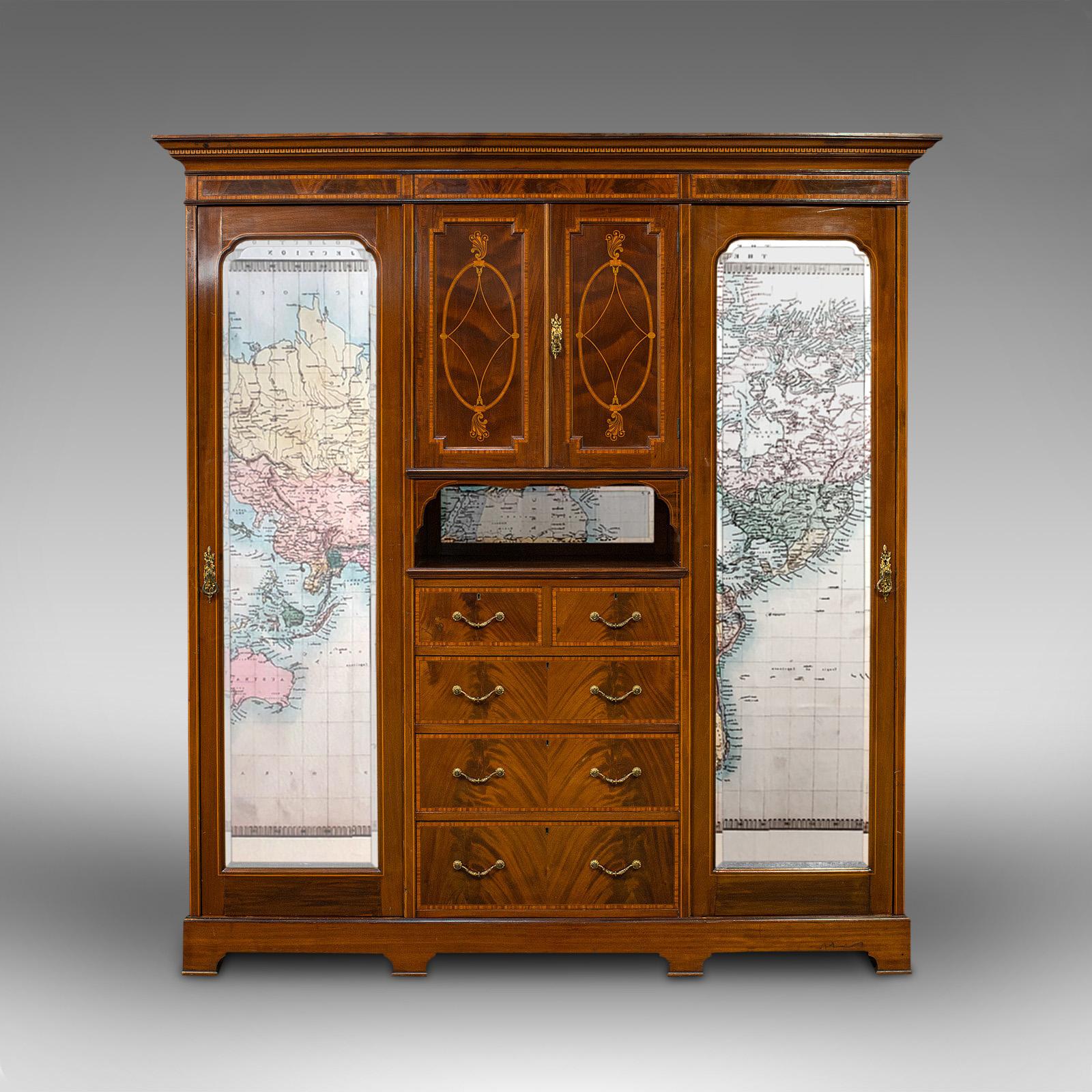 This is an antique gentleman's triple wardrobe. An English, mahogany and satinwood inlaid cabinet, dating to the Victorian period, circa 1880.

Utterly striking craftsmanship upon a generously sized piece
Displaying a desirable aged patina and