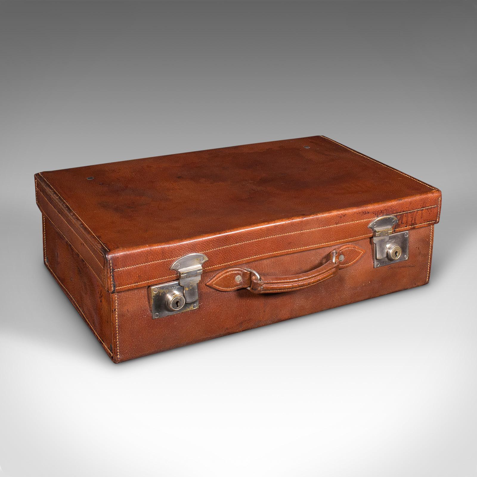 
This is an antique Gentleman's valet suitcase. An English, leather fitted case with silver topped bottles, dating to the early 20th century, circa 1920.

Superb fitted suitcase, replete with everything a travelling gent could need
Displays a
