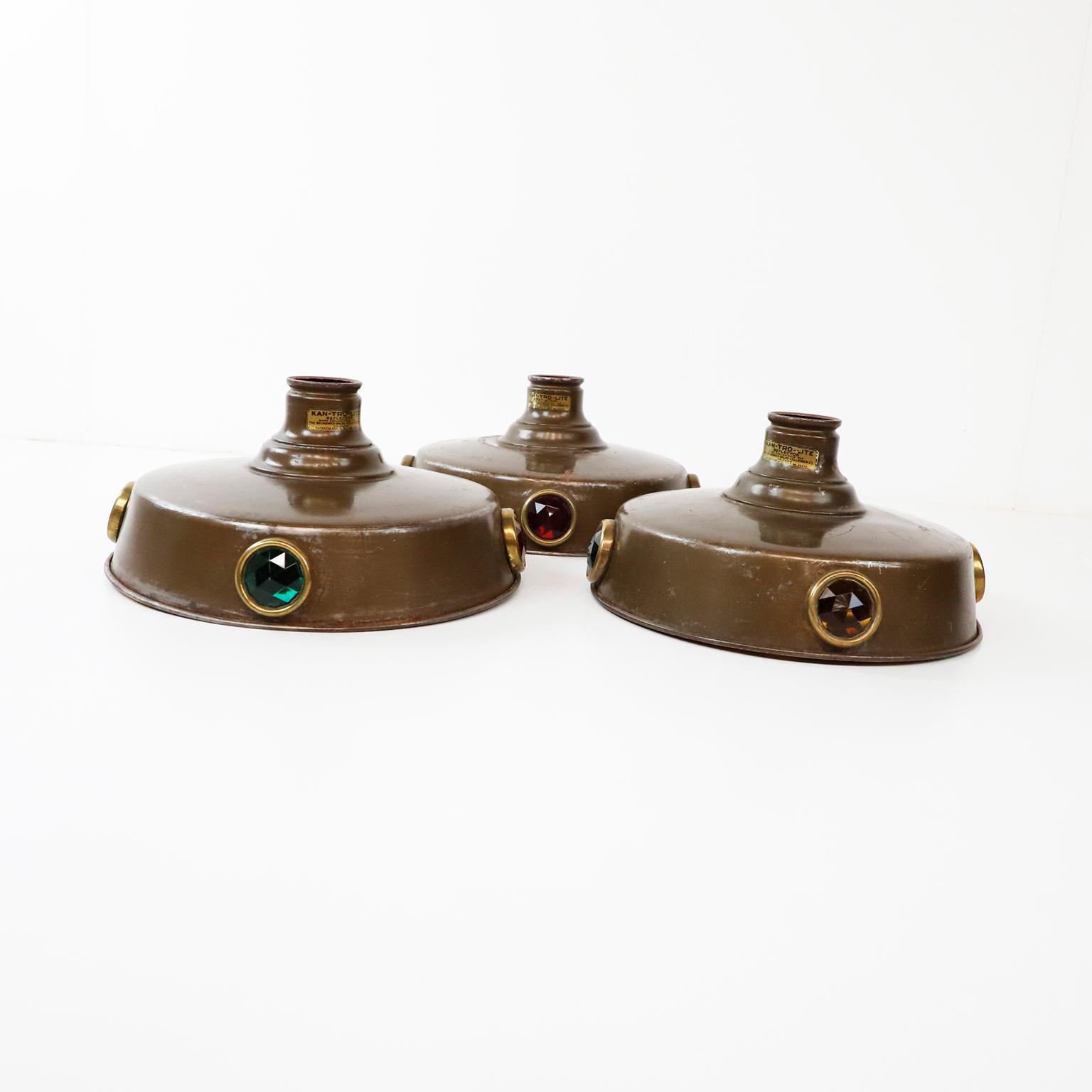 Circa 1930. We offer this set of three Antique Brunswick pool table lights shades. Genuine Kan-Tro-Lite brand shades, each with four diamond-cut colored glass inserts. Original diamond-shaped brass loops. A rare pieces of billiard history.