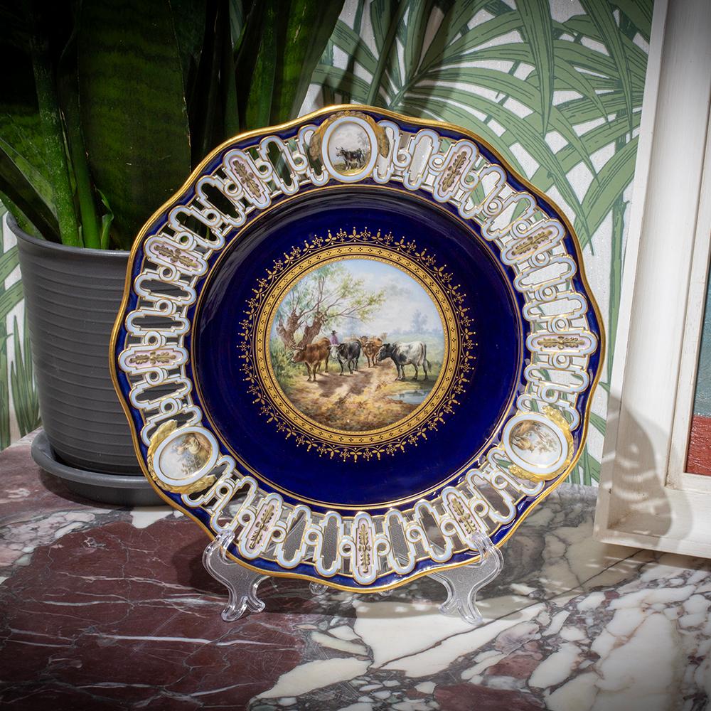 With Finely Painted Cattle Scenes 

From our Ceramics collection, we are delighted to offer this very unusual Meissen Reticulated Porcelain Plate. The Meissen Plate is beautifully potted with a rare reticulated border having three finely painted