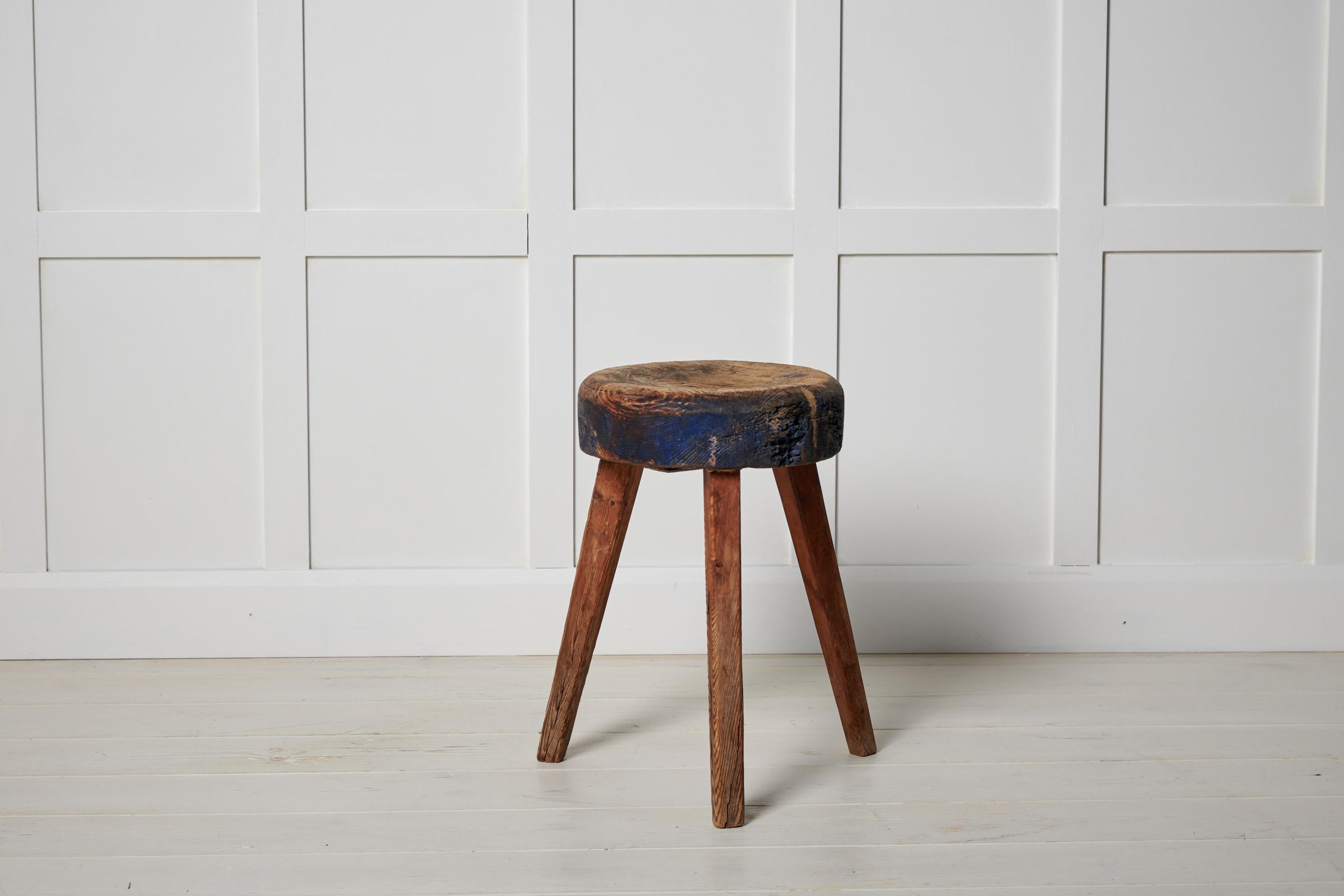 Antique Swedish country stool made in northern Sweden around the mid 1800s. The stool is made by hand from solid pine. It has a round, unusually thick seat with three legs. In charming, untouched original condition with the authentic patina. Some