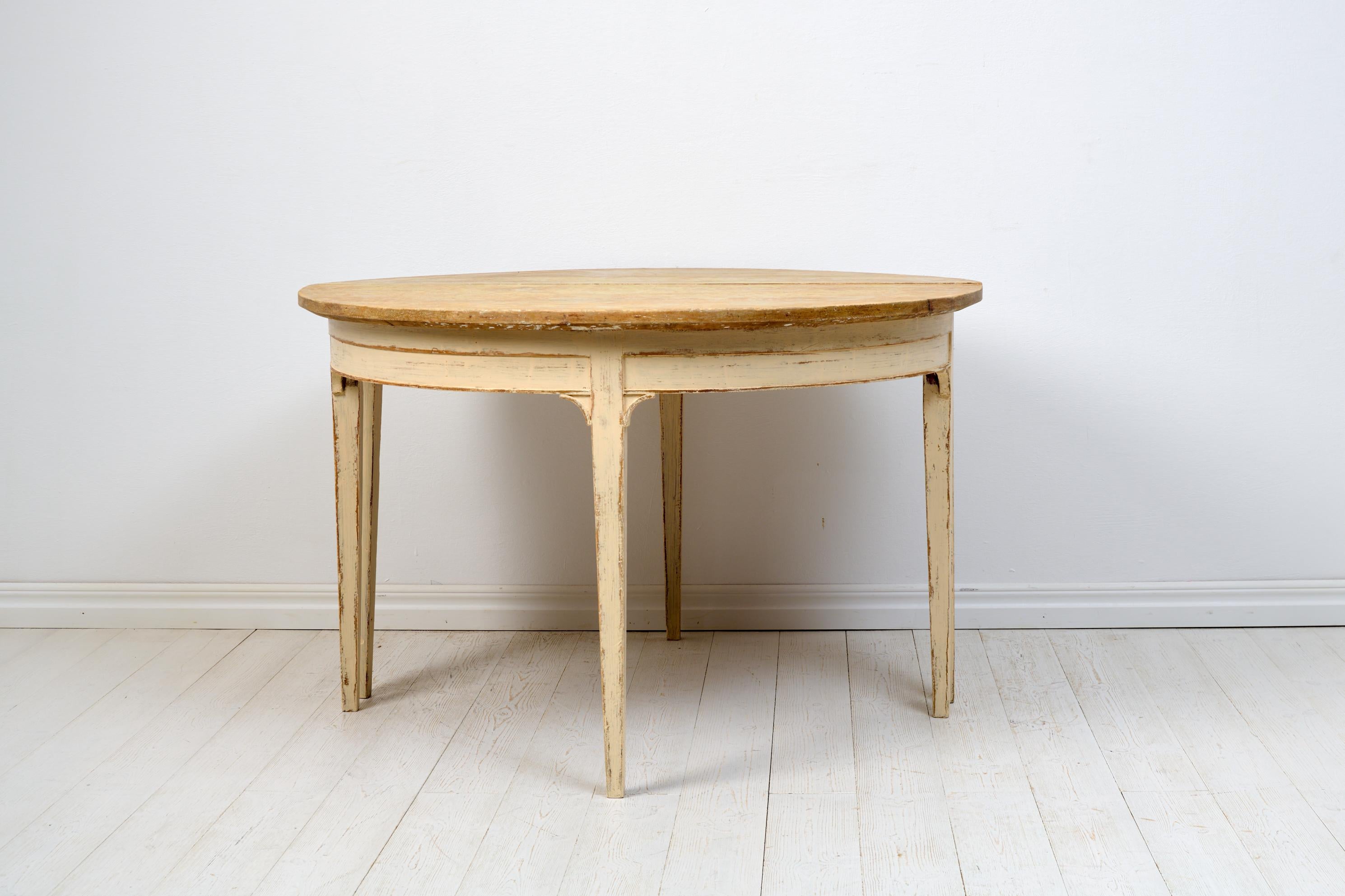 Genuine Swedish demi-lune table. The table consists of two freestanding half-circle tables with straight tapered legs and corner consoles between the legs and apron. They can be used separately, for example as console tables, or together as a round