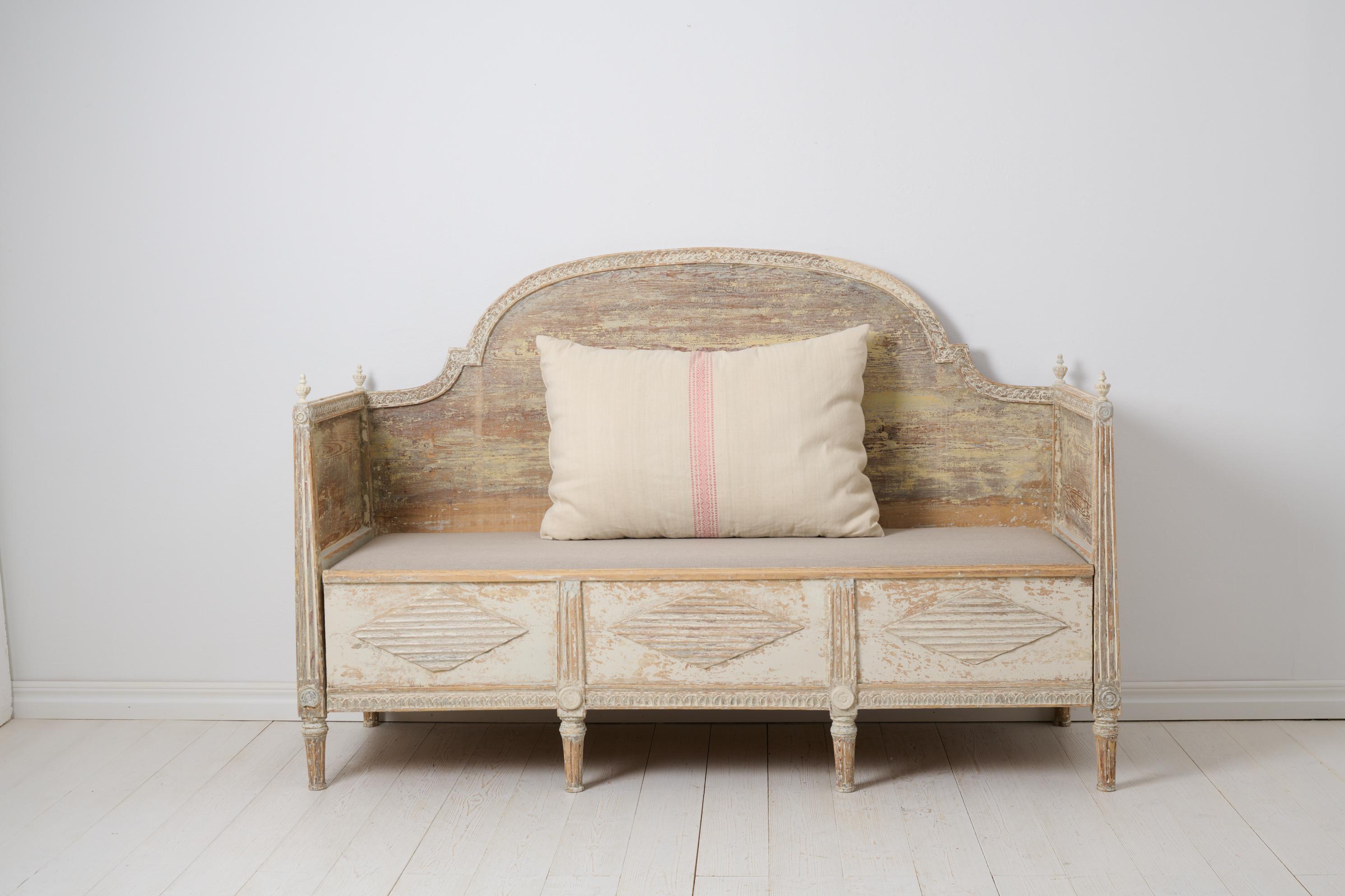 Antique Swedish sofa in gustavian style. The sofa is a genuine country house furniture made by hand around 1820 in northern Sweden. The frame is made in solid pine and the surface has been dry scraped by hand down to the first layer of paint,