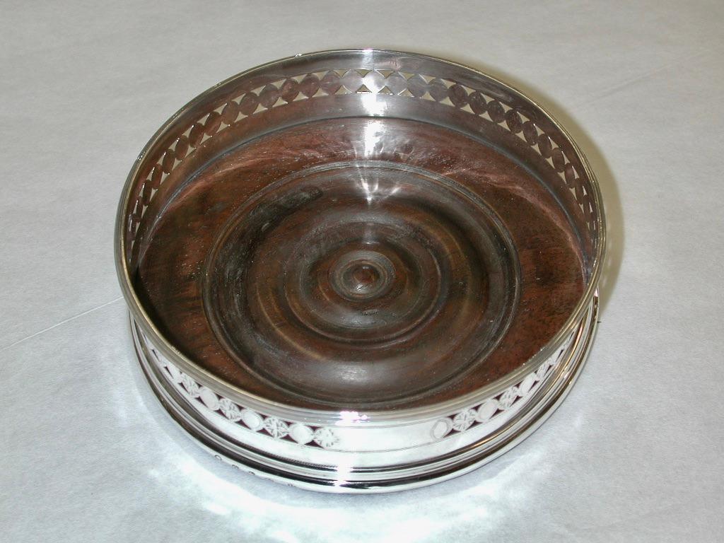 Antique Geo 111 Silver Wine Coaster Dated 1791  made by Robert  Hennell 11 of  London
Lovely decoration of hand piercing and bright cut engraving with a thread edging on top.
Nicely turned mahogany base with baize underneath.

