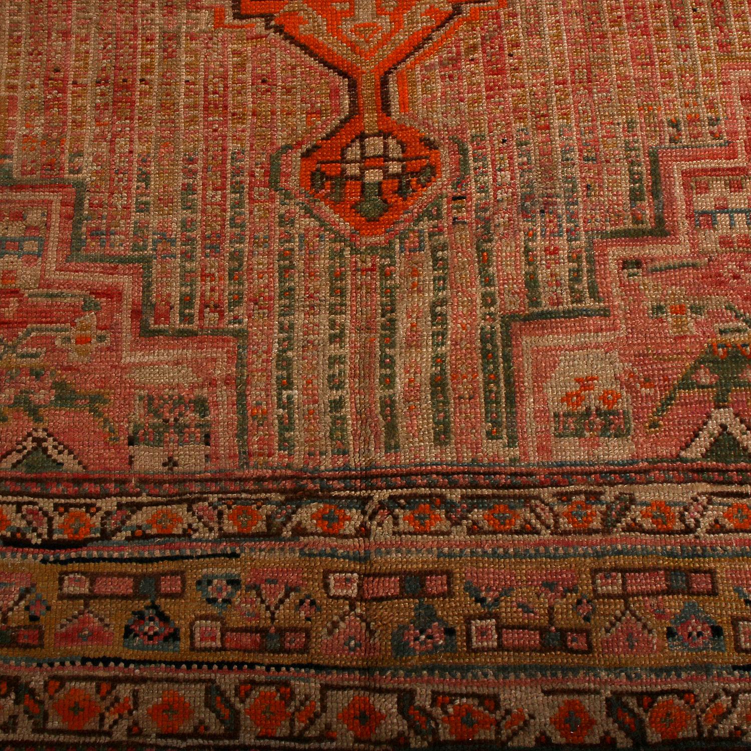 This 7x12 antique Persian is a mid-century tribal carpet believed to be of Qashqai origin. Hand-knotted in wool circa 1910-1920, its design favors medallions and geometric patterns in red, beige-brown and gold. 

On the Design:  

Connoisseurs will