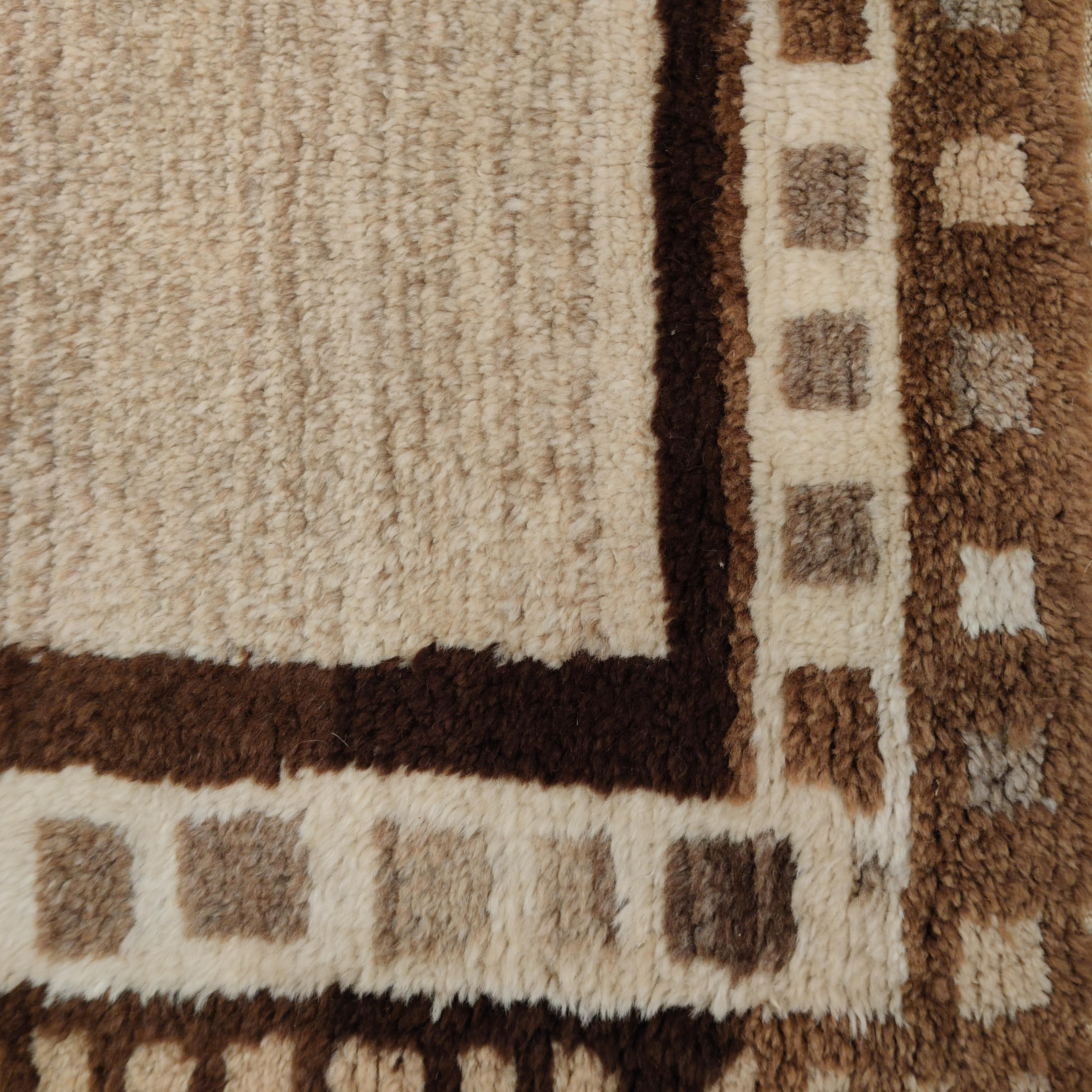 A truly elegant Kurdish Anatolian tribal rug from eastern Turkey distinguished by the use of natural, undyed camel hair for the background. It's sparsely decorated by a sequence of five conjoined diamond medallions with stepped outlines in tones of