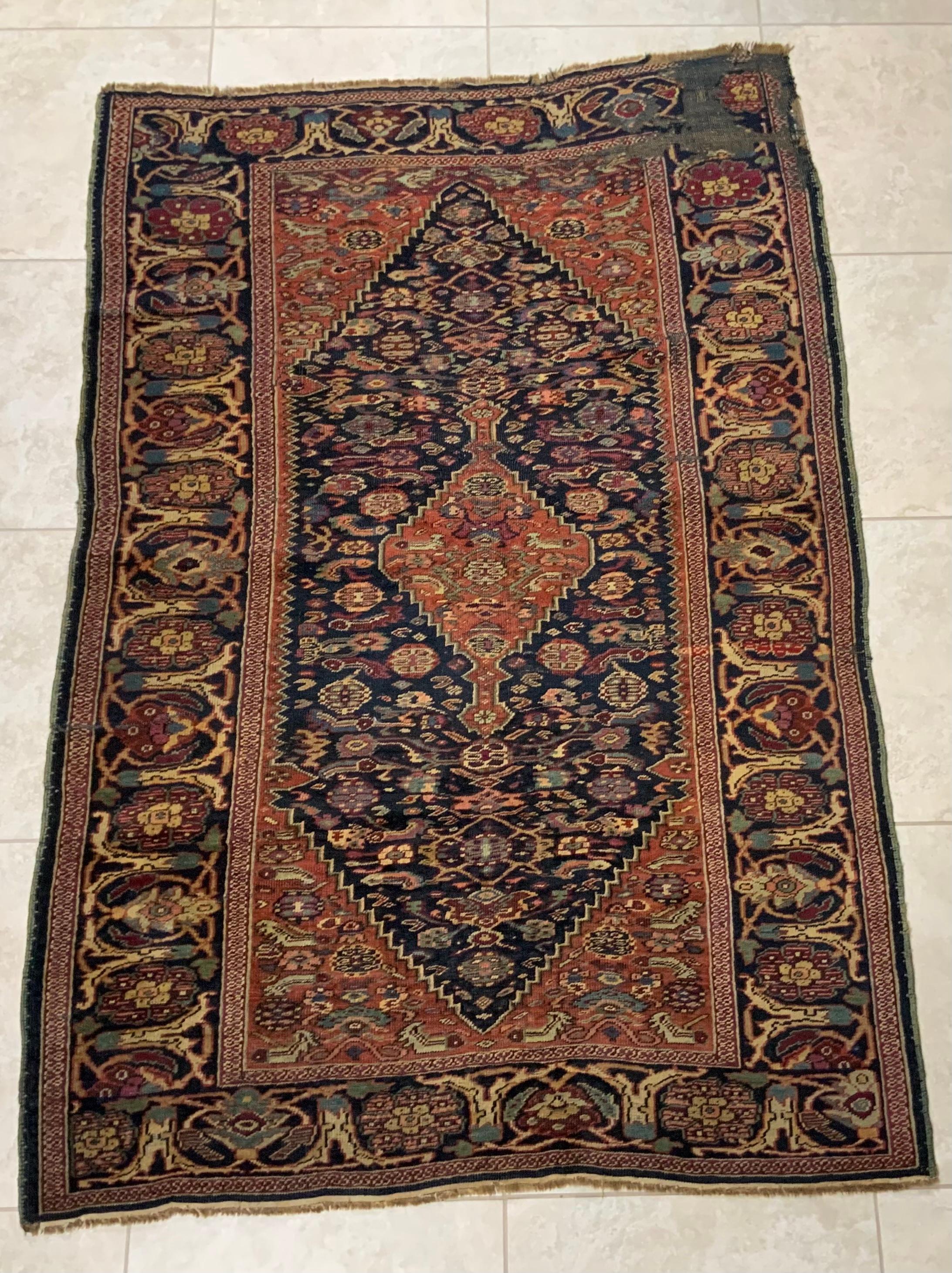 Exceptional oriental rug made of fine wool with beautifully executed geometric and floral motifs, beautiful small and medium medallions surrounded by intricate wide Border. The rug handwoven by nomadic family. In one corner area missing and low pile