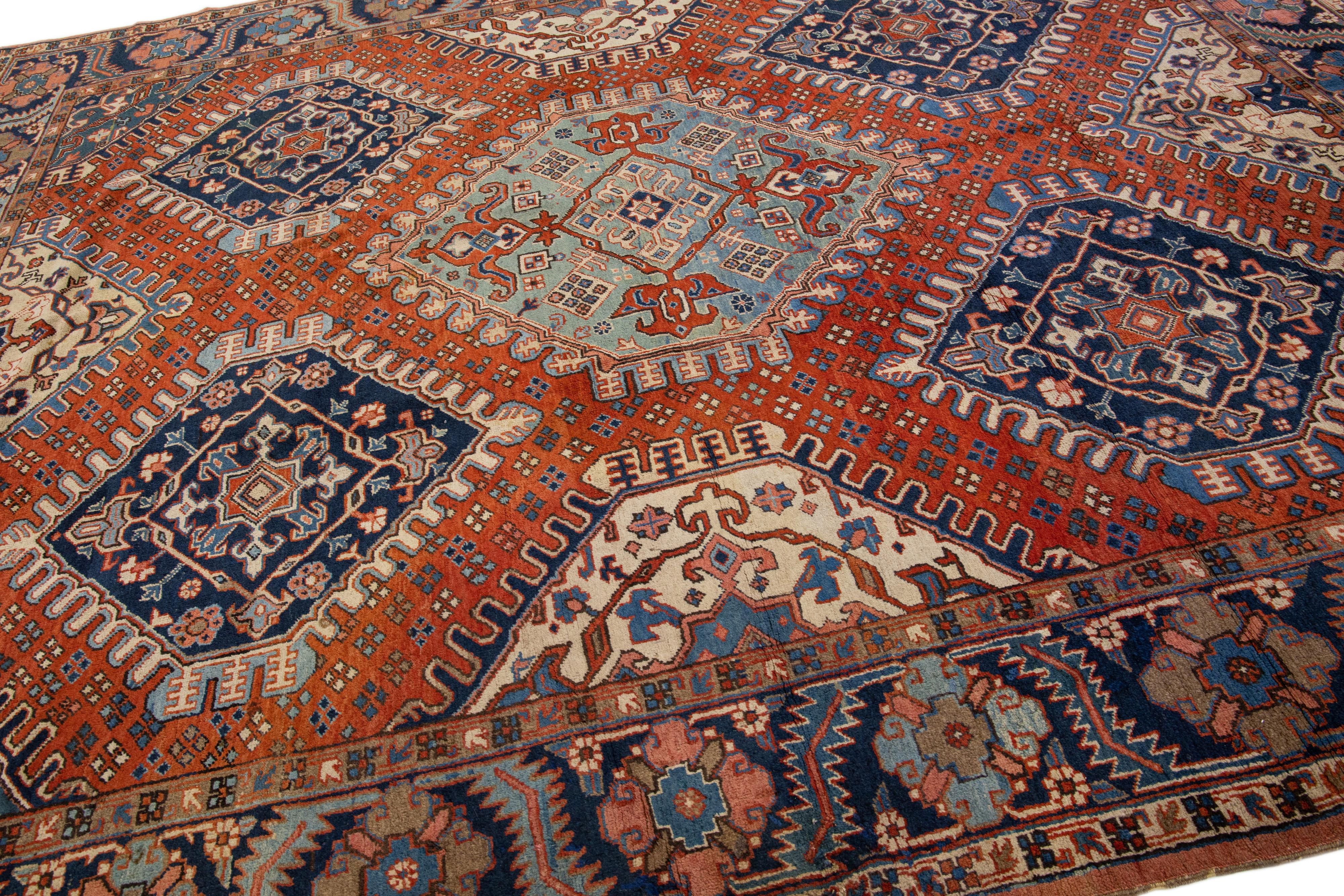 Hand-Knotted  Antique Geometric Persian Heriz Handmade Wool Rug with Orange Rust Field For Sale