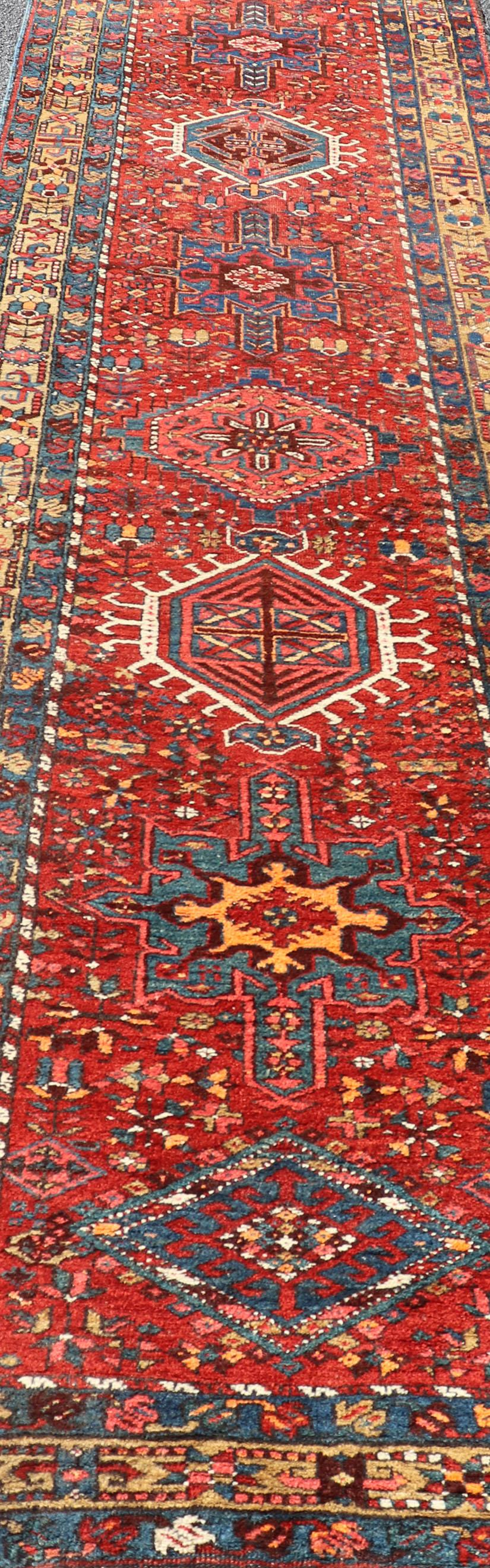 Early 20th Century Antique Geometric Persian Long Heriz Runner in Red, Blue, Yellow, Teal, Orange For Sale