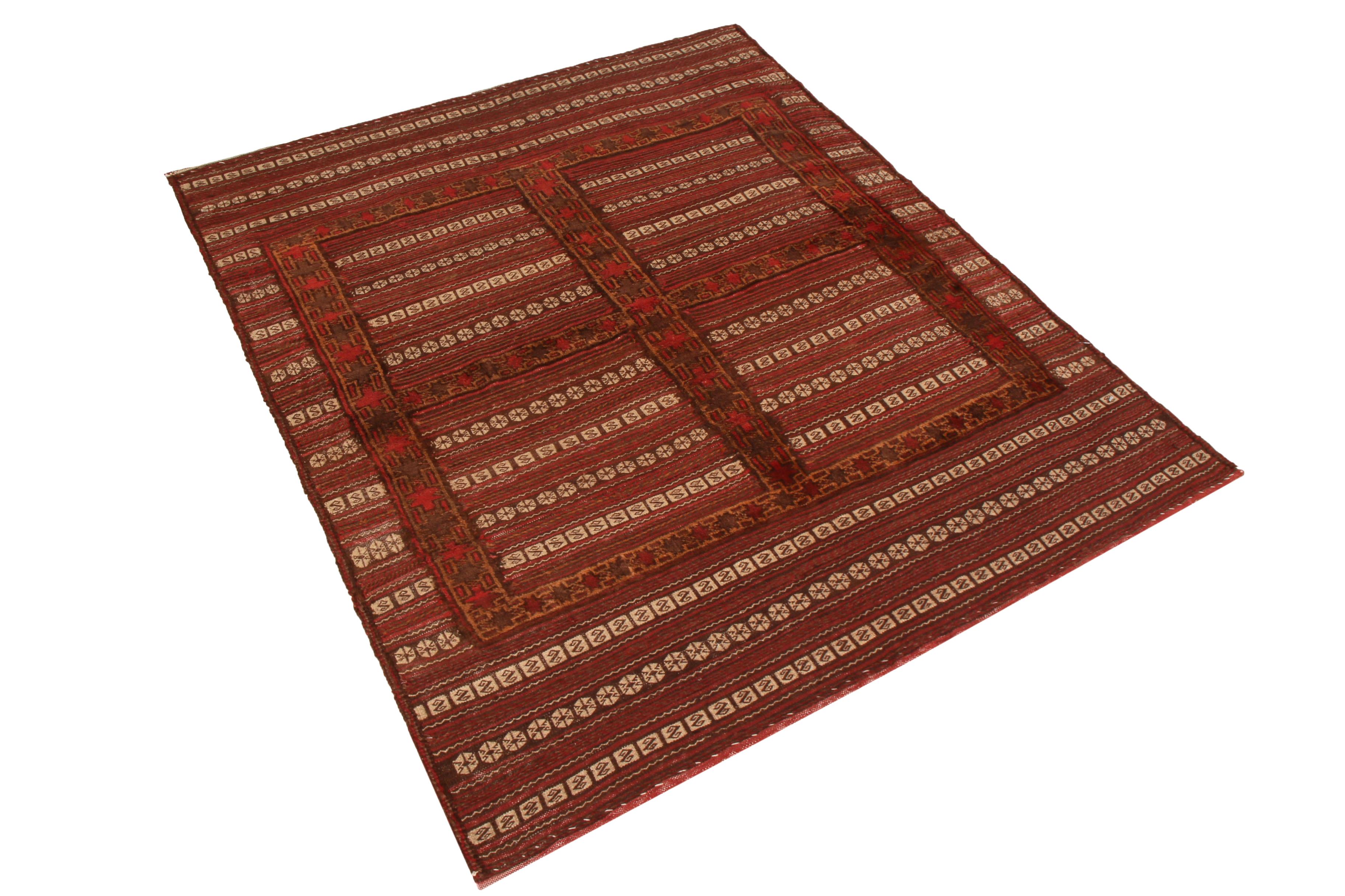 Made with handwoven wool originating from Afghanistan between 1890-1900, this antique kilim enjoys a meticulous, refined weave highlighting the rich repeating geometric-floral motifs through a tactful juxtaposition of beige with the richer brown and