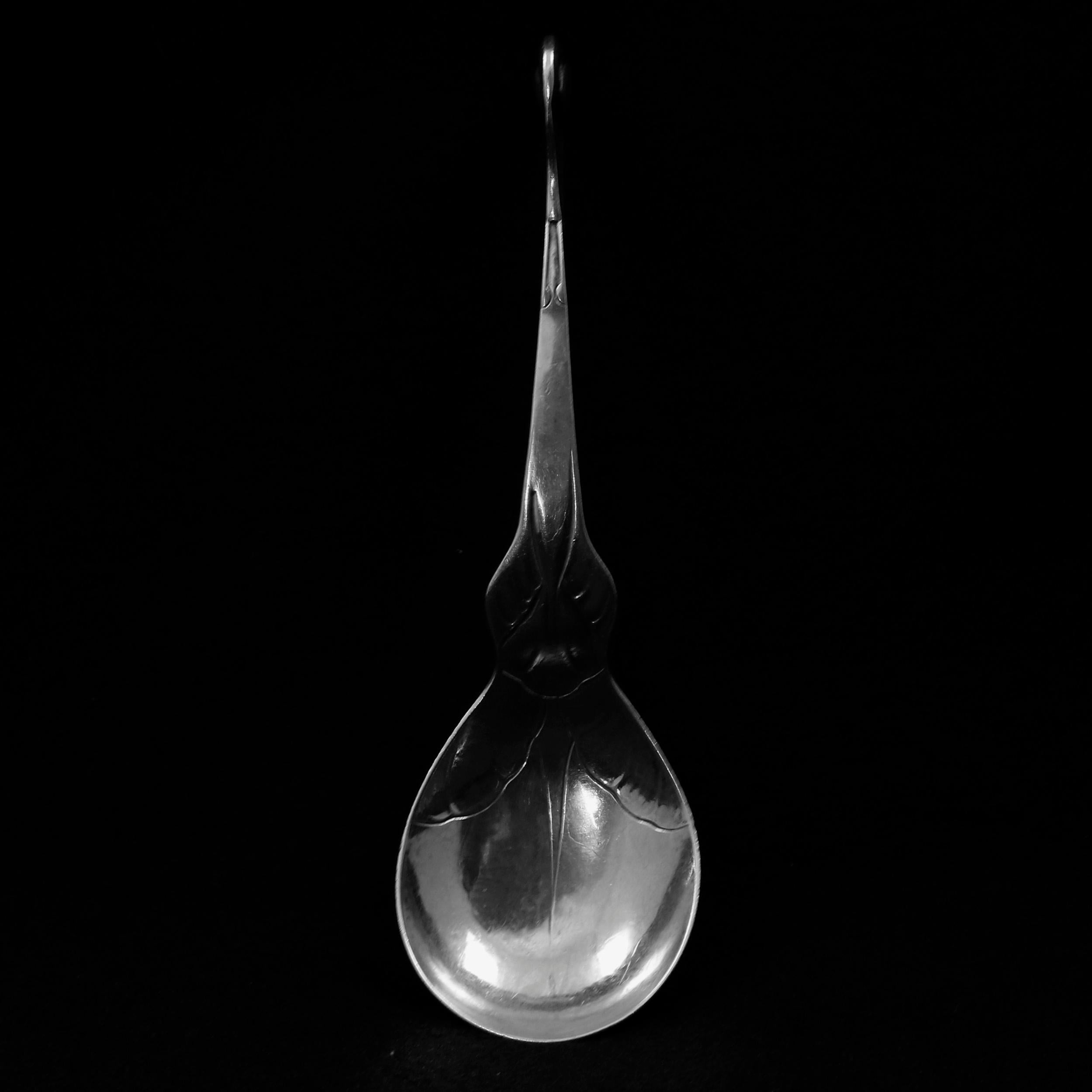 An antique sculptural serving spoon by Georg Jensen offers sterling silver construction with Nautilus form handle and stylized floral incised bowl, signed en verso as photographed, circa 1930.


Measures: 7.25