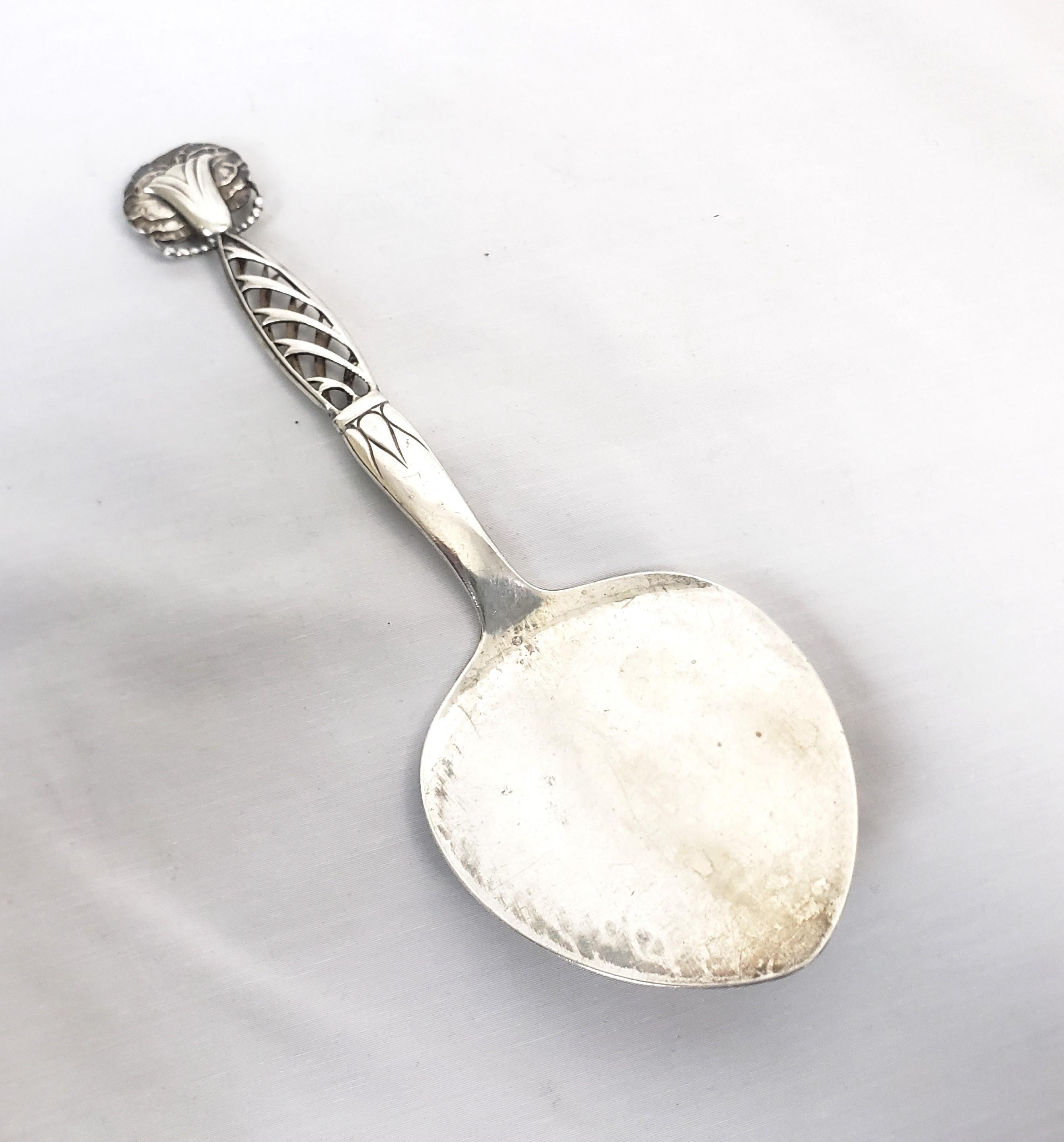 This antique tomato server was made by the renowned Georg Jensen of Denmark and dates to approximately 1920. This server is done in his rare 'Ornamental 83' and is composed of sterling silver. The piece is clearly signed on the back with the Jensen
