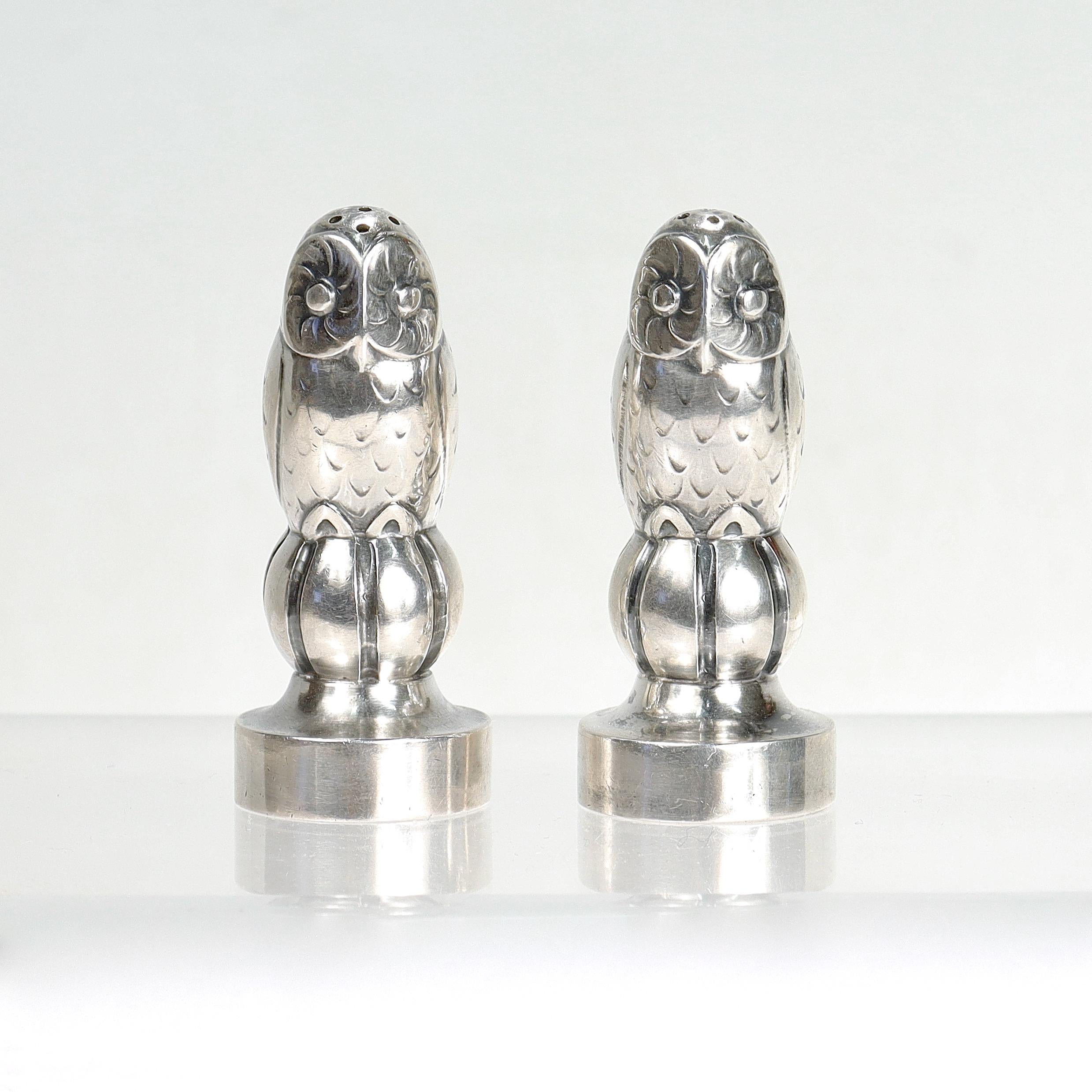 A fine pair of antique salt and pepper shakers.

By Georg Jensen. 

In sterling silver.

Model. no. 36.

Designed by Georg Jensen.

Each modeled as an owl perched on a ribbed ball supported by an everted foot. 

One with a replaced foot cap.

Each