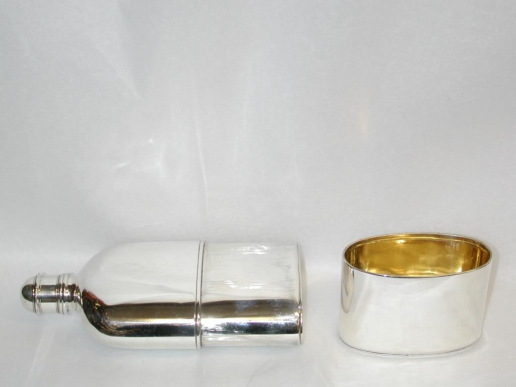 Antique George 1V silver flask made by John Reily of London.
This exquisite flask has a solid silver stopper, which is separately hallmarked, as is the screw down top.
The detachable drinking cup is also separately hallmarked and is gilt inside.