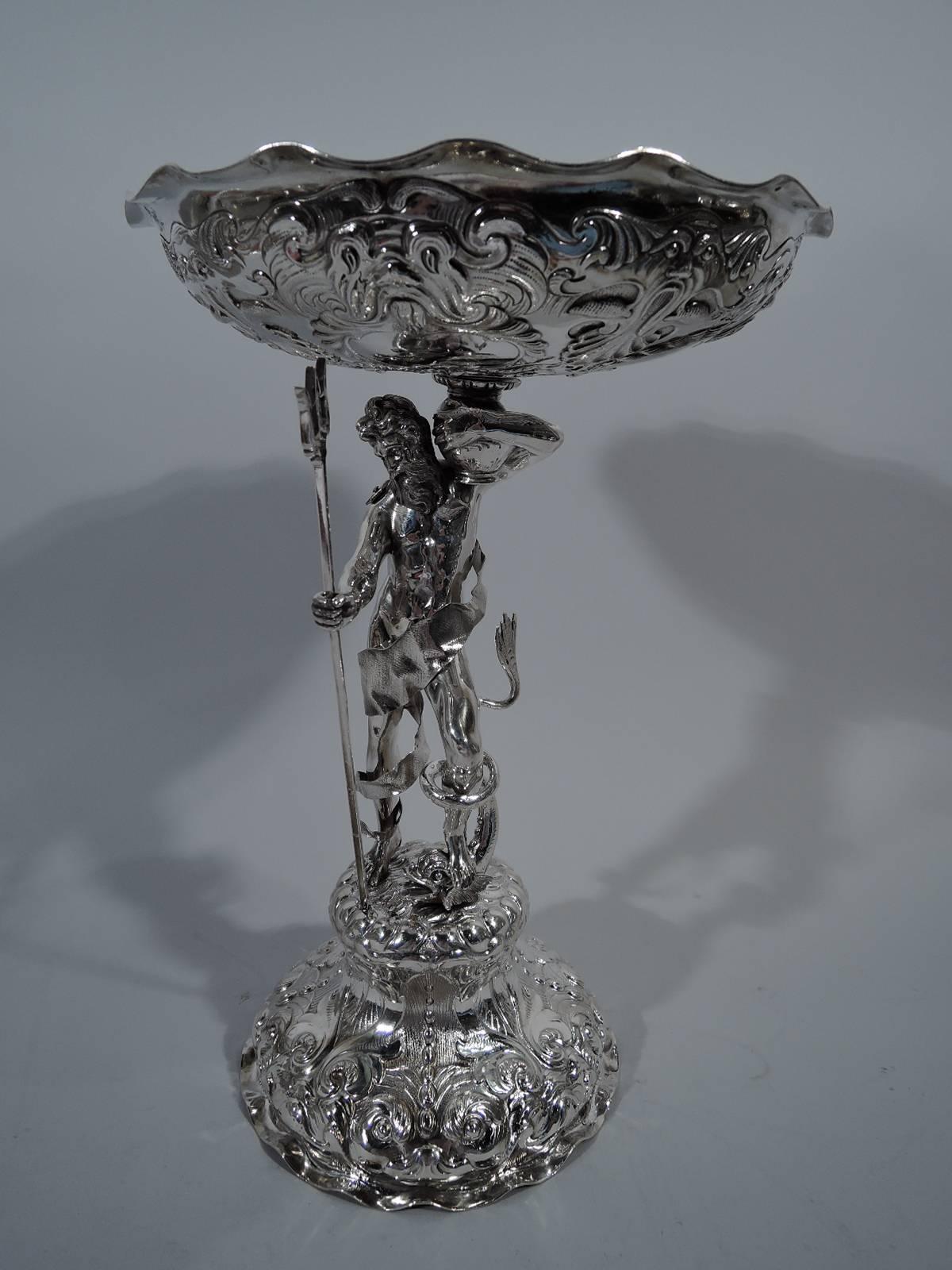 Pair of Victorian sterling silver centerpiece compotes. Made by George Fox in London in 1868. Each: Neptune holds his trident in his right hand and shoulders a vase with his left. The right foot is firmly planted while the left rests on a dolphin