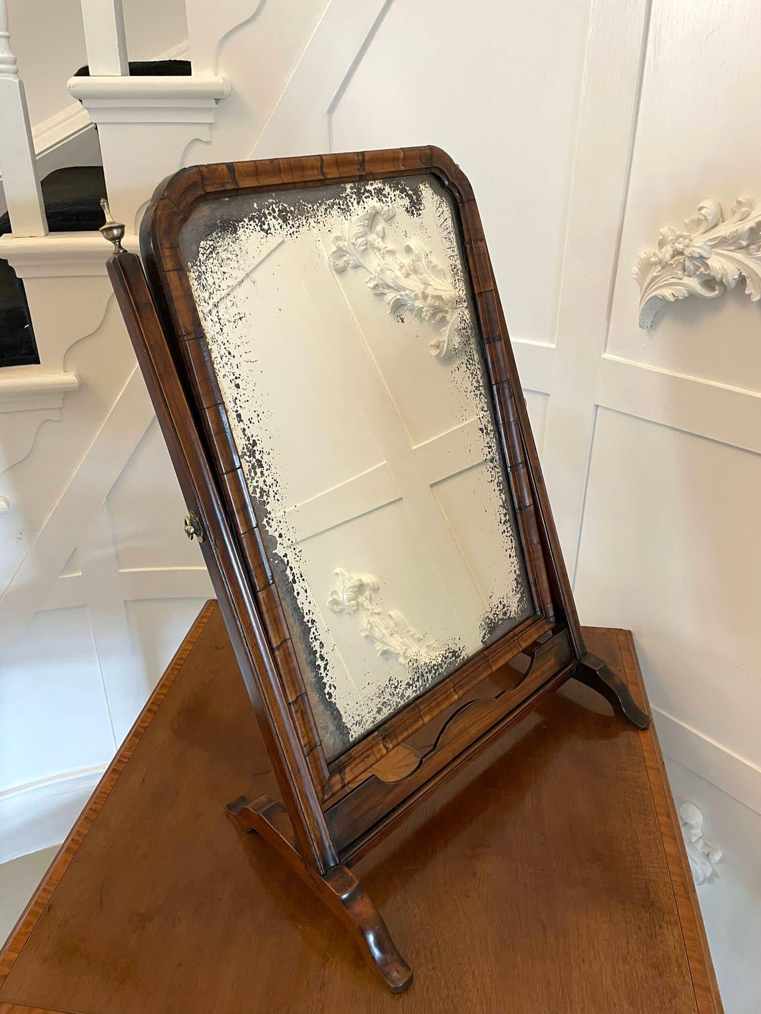Antique George I quality figured walnut dressing table mirror having the original mirror plate in a figured walnut moulded frame supported by two moulded uprights standing on shaped cabriole feet united by a walnut stretcher 

A lovely original