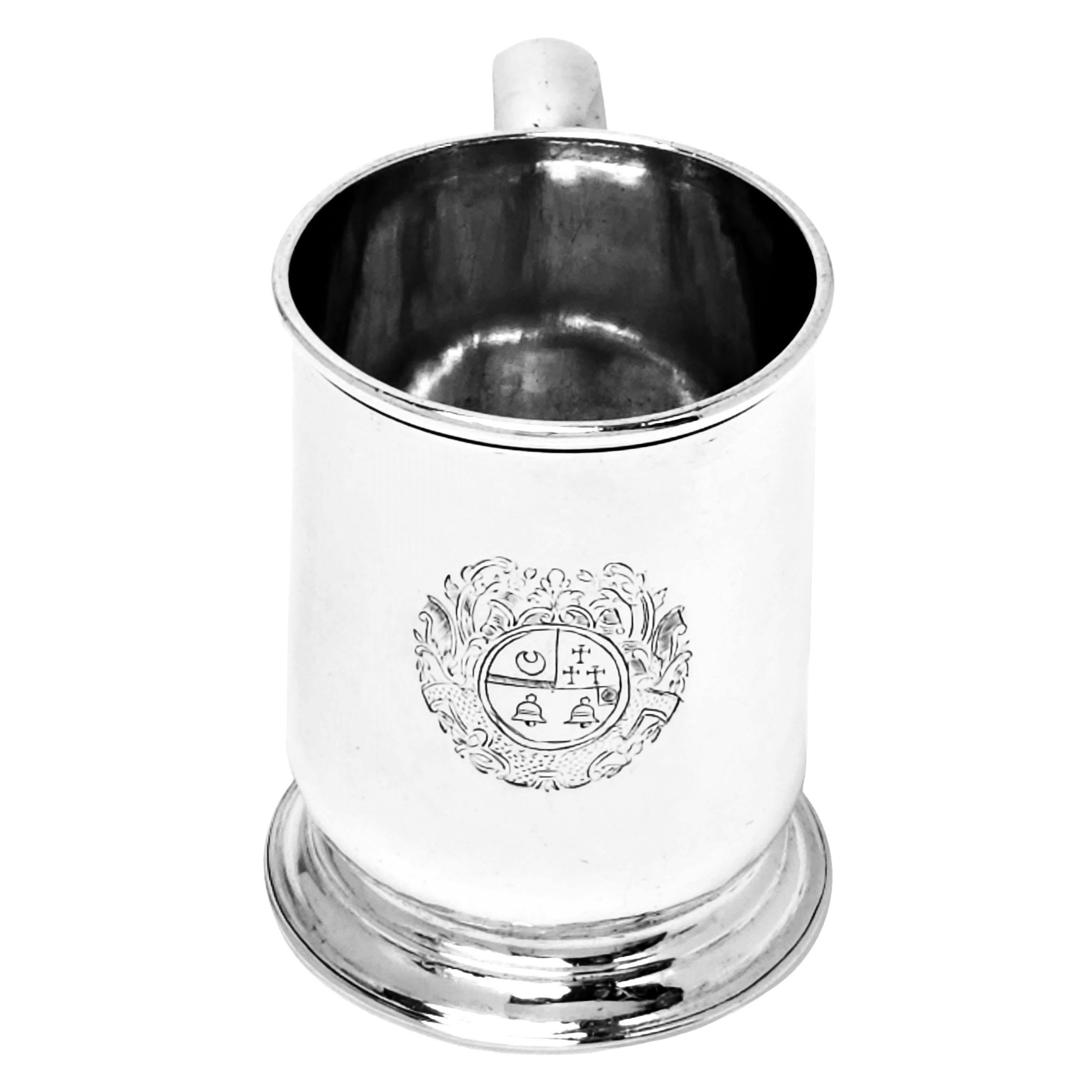 A classic antique George I sterling silver 1/2 Pint Mug with a round spread pedestal foot. The Beer Mug has an engraved crest on the side opposite the scroll handle.

Made in London, England in 1722 by John East.

Measures: Approx. Weight - 246g