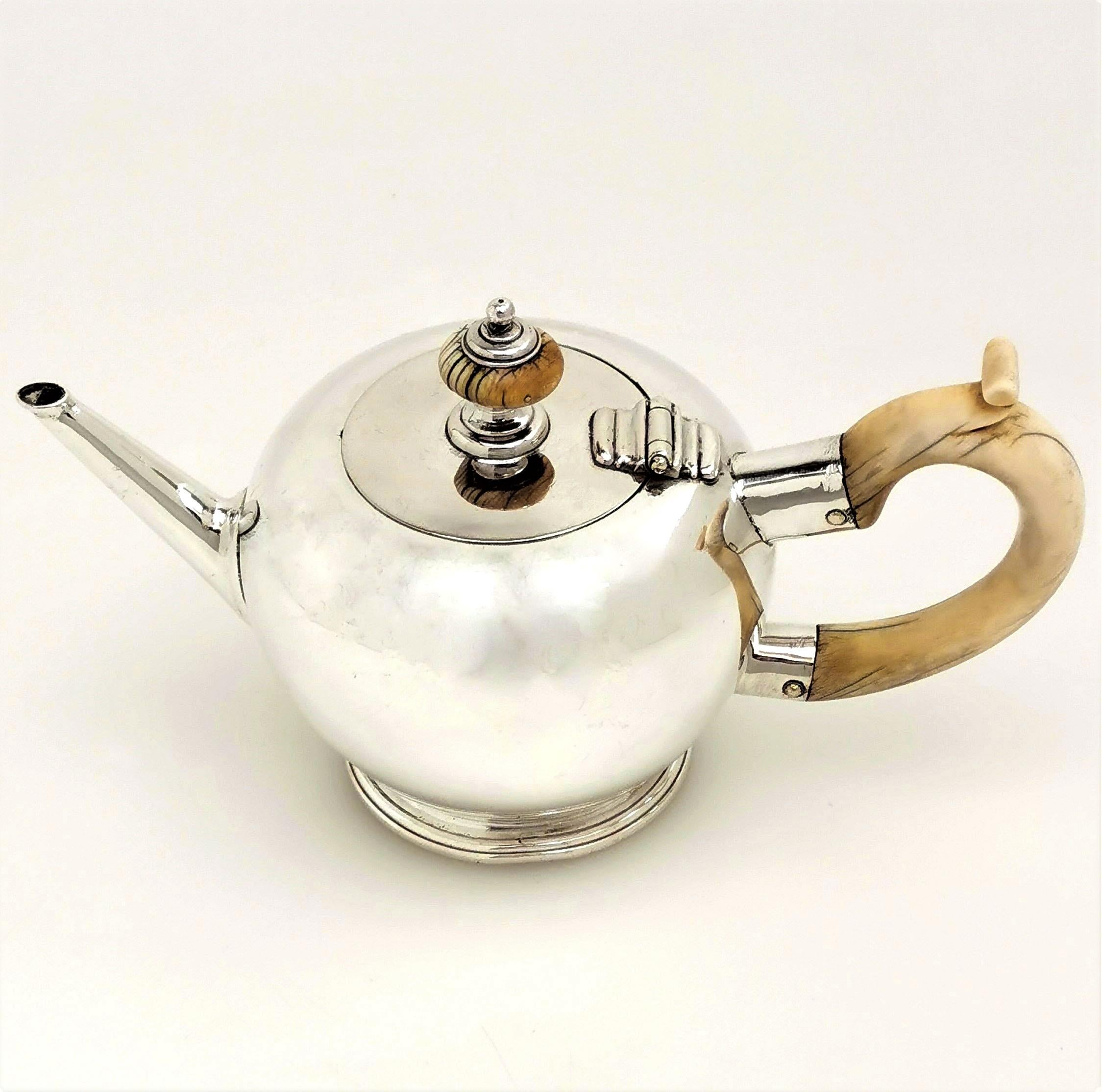 A lovely Antique George I Solid Silver Teapot. This small silver Teapot is perfect for single servings and as such is known as a Bachelor Teapot. The Tea Pot has a cream handle and finial. This Teapot is an excellent example of the classic