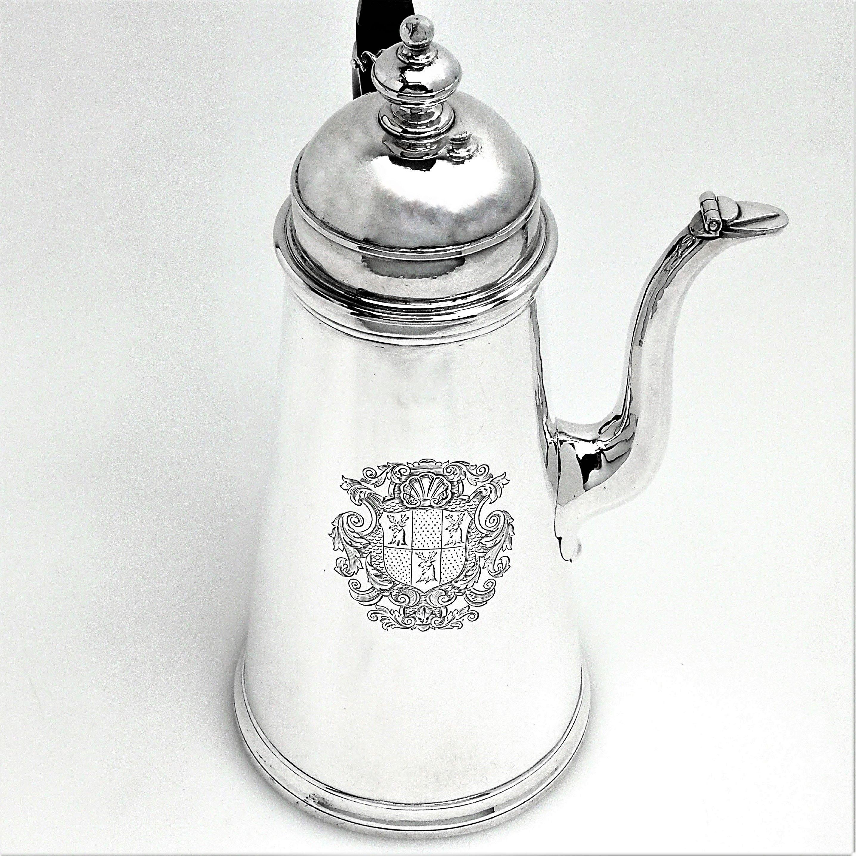 An excellent antique George I solid Silver side handled Coffee Pot with an impressive engraved armorial opposite the wooden scroll handle. The elegant tapered body of the Georgian Coffee Pot has a hinged domed lid with a round finial.
 
 Made in