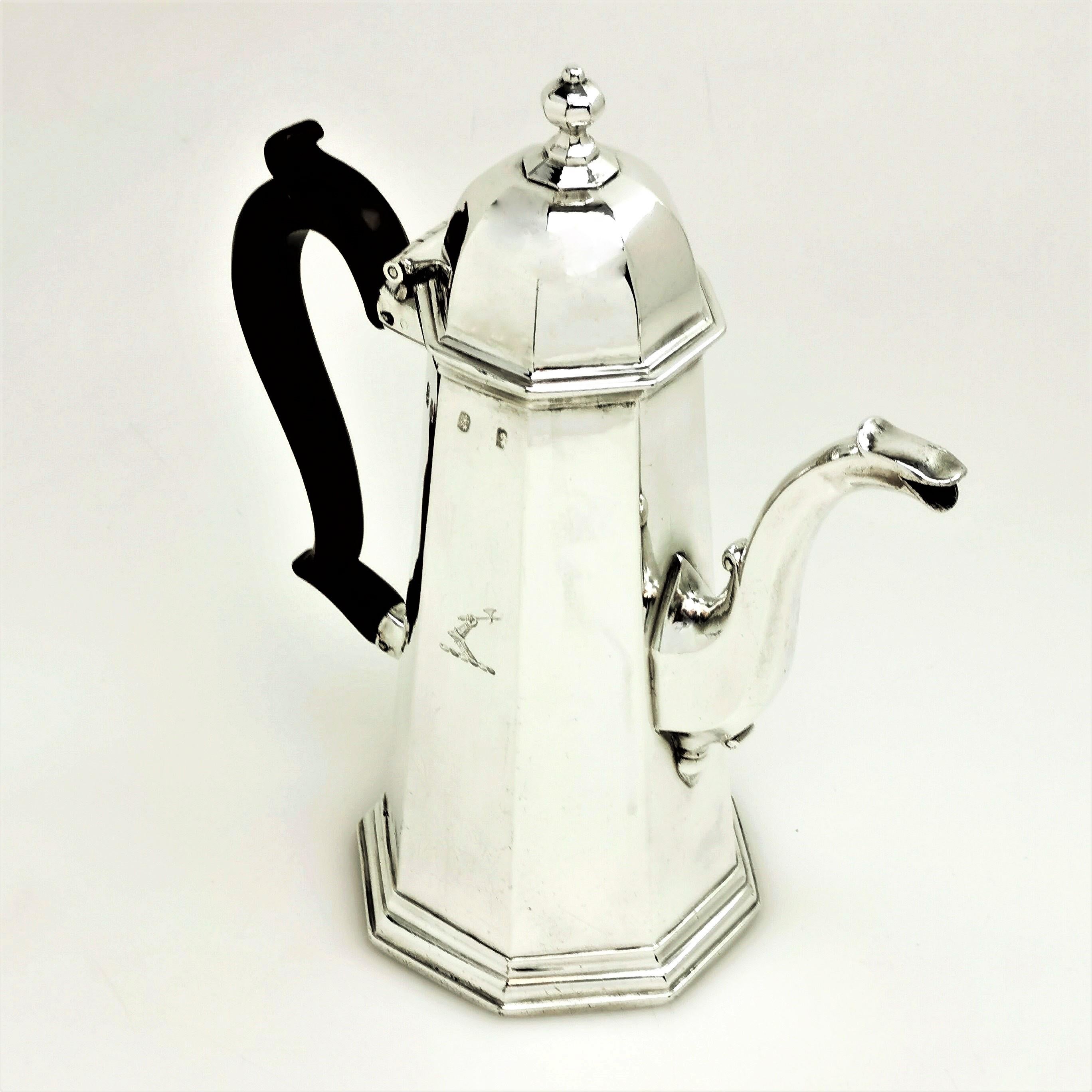 An exceptional George I solid Silver Coffee Pot with a classic tapered octagonal body and a domed octagonal hinged lid. The Georgian Coffee Pot has an elegant wooden scroll handle and has a small crest engraved on the body.

Made in London in 1719