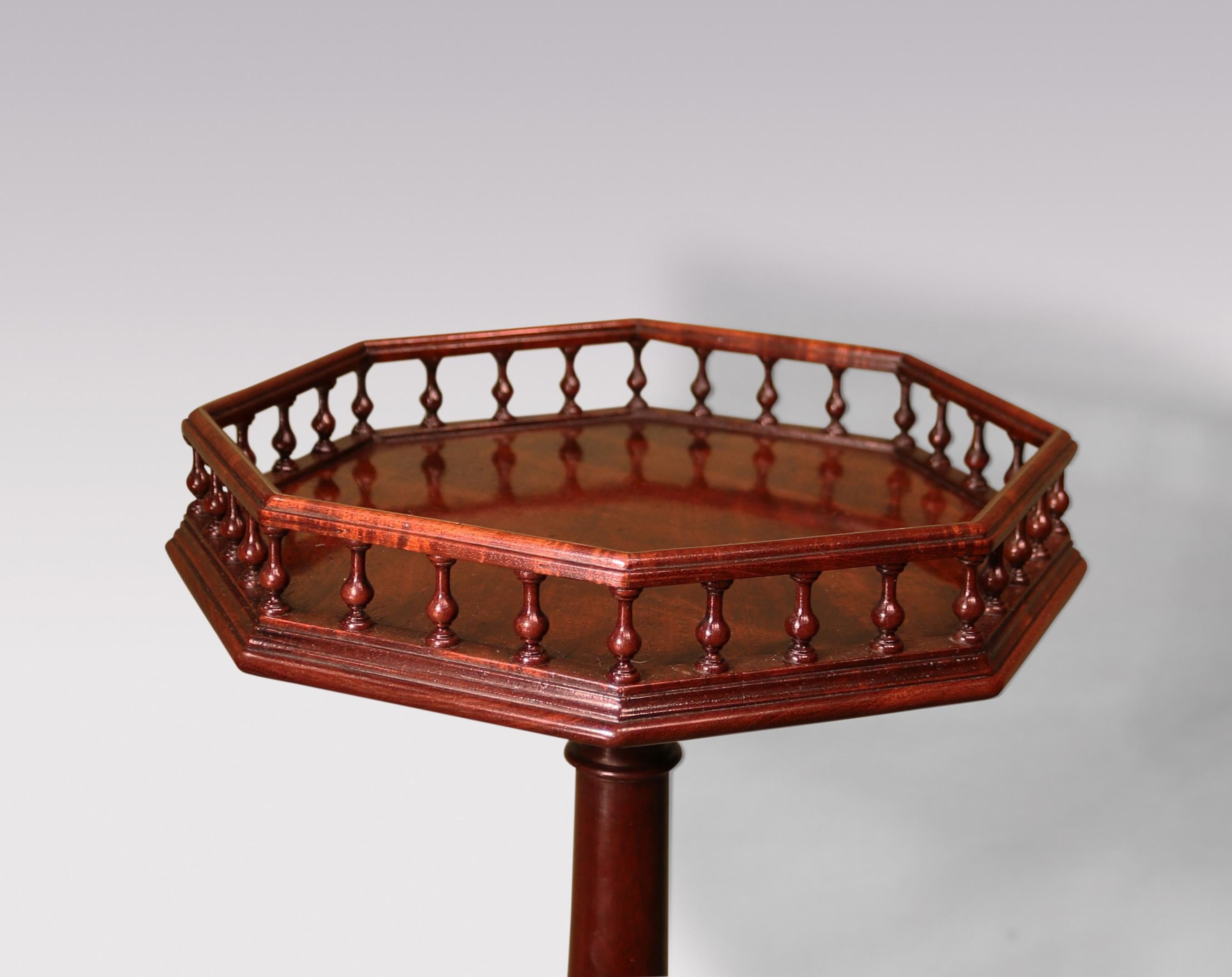 A fine mid-18th Century George II period mahogany octagonal top Kettle Stand, having spindle gallery with brass line inlay to top edge.  The Table raised on baluster turned stem ending on tripod base with pad feet.