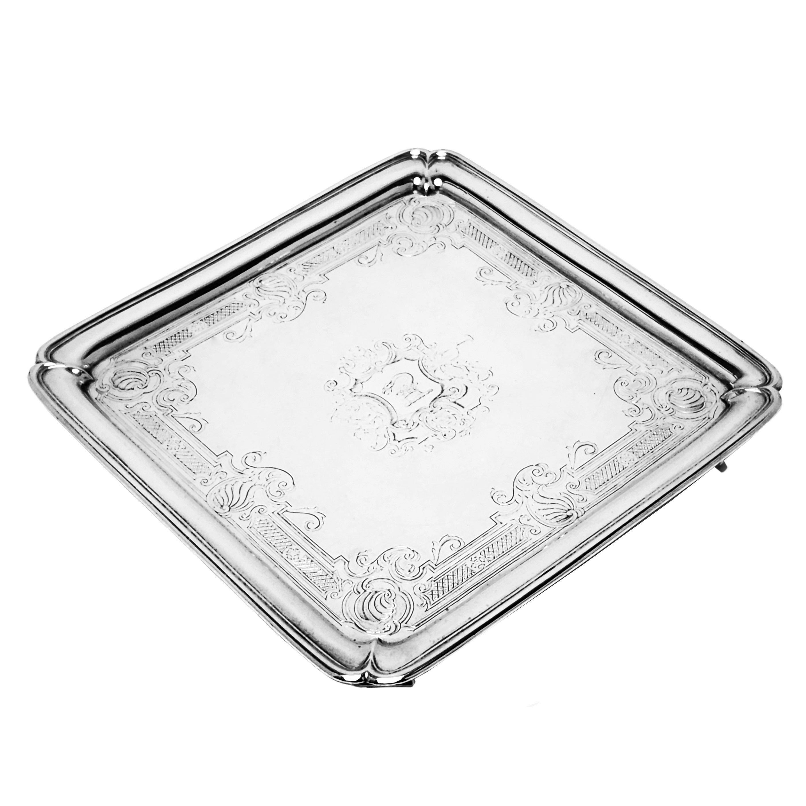 A lovely Antique George II Solid Silver Salver. This Square early Georgian Salver stands on 4 shaped feet and is embellished with an elegant engraved border surrounding an armorial.

Made in London, England in 1733 by Ayme Videau.

Approx. Weight -