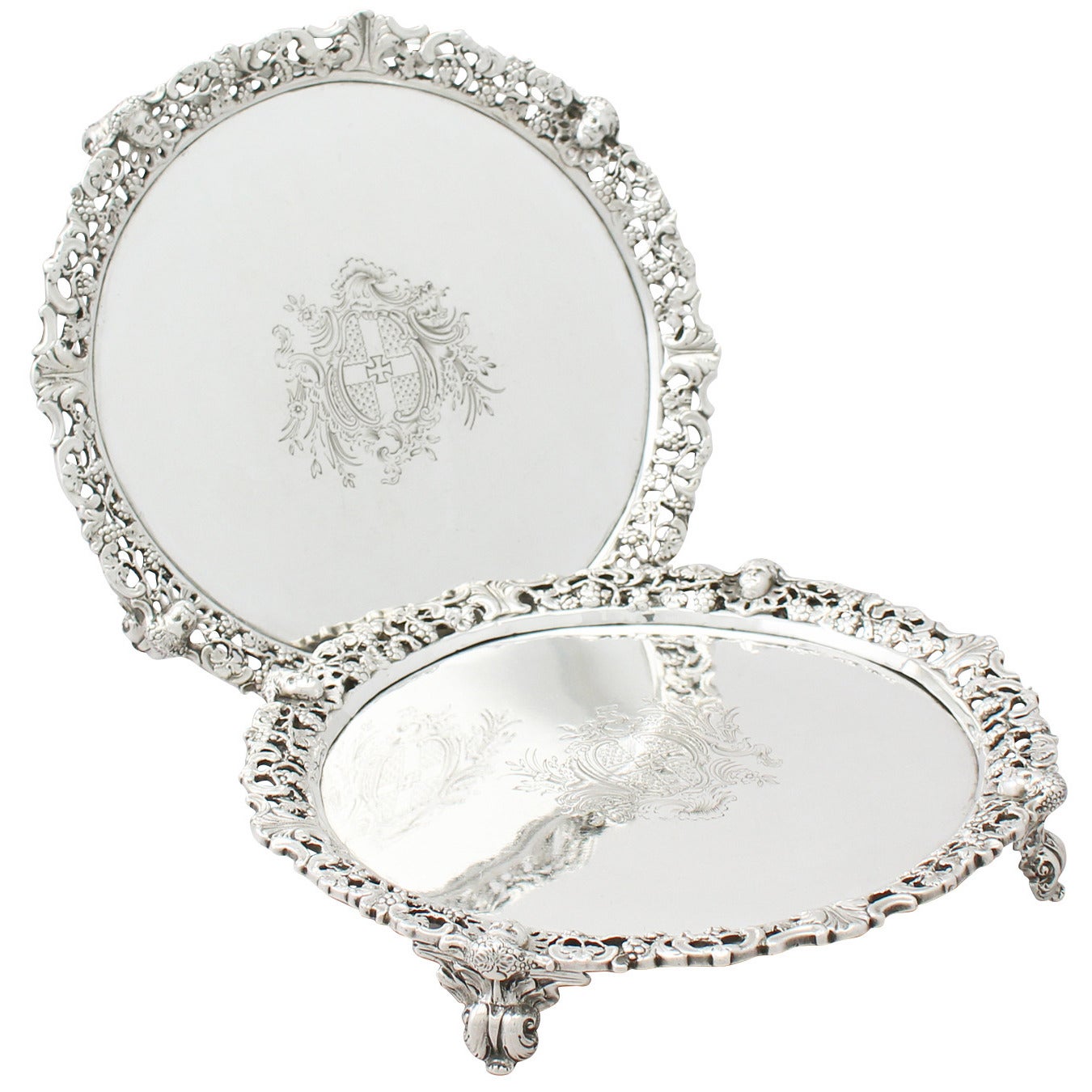 An exceptional, fine and impressive pair of antique Georgian English sterling silver salvers; an addition to our tray and salver collection

These exceptional antique George II sterling silver salvers have a circular shaped form.

The surface of