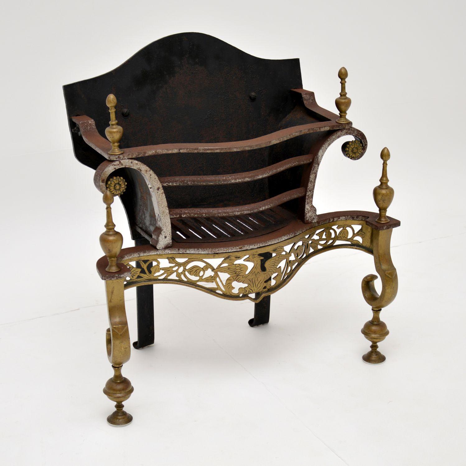 A charming antique fireplace basket, made from steel, iron and brass. This dates from the early twentieth century, probably 1920s and is very much George II in style.

It is of great quality and is ornately decorated in the neoclassical style.