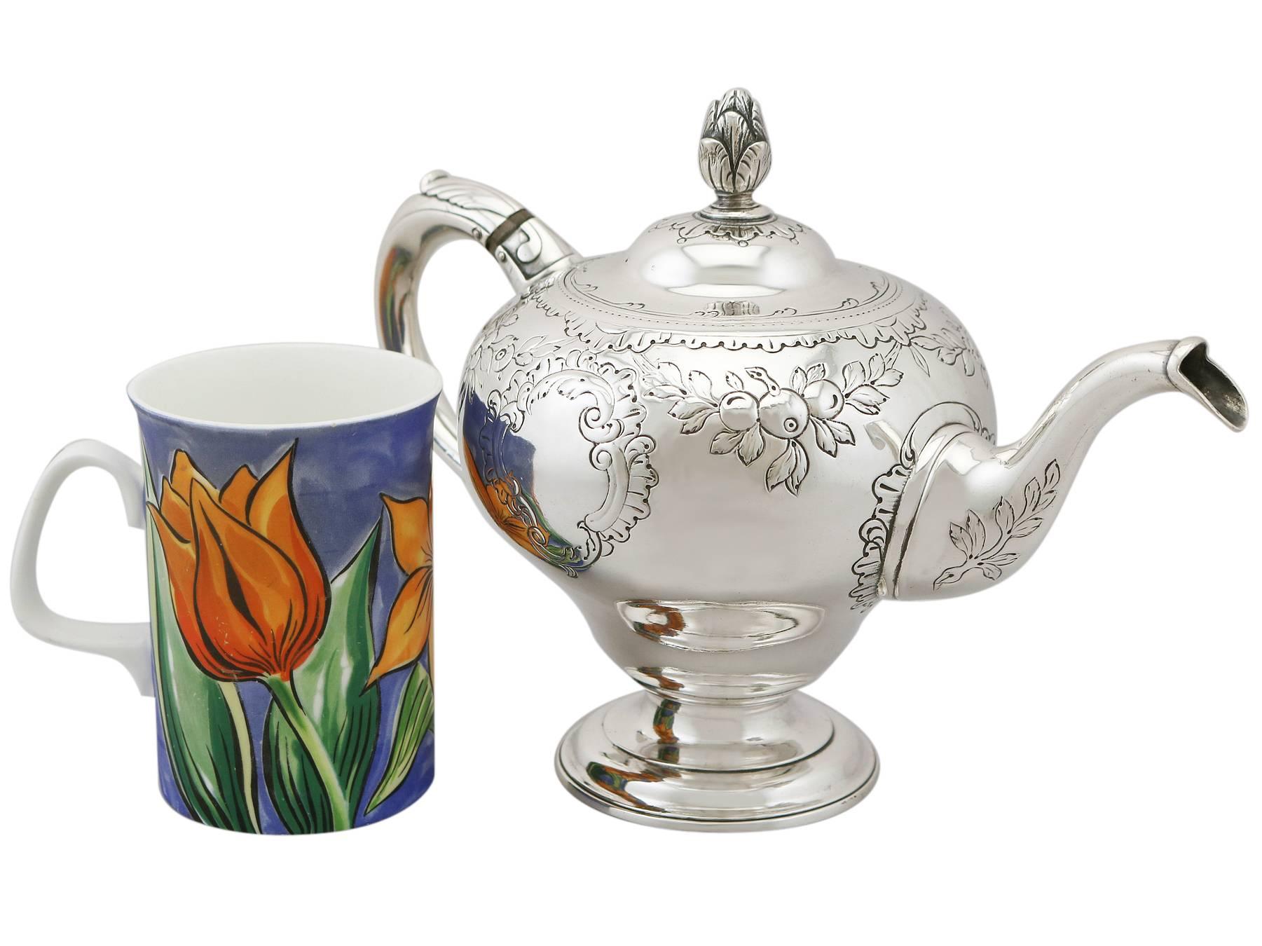 An exceptional, fine and impressive antique Georgian Scottish sterling silver teapot; an addition to our 18th century silver teaware collection.

This exceptional antique Georgian Scottish sterling silver teapot has an inverted pear shaped form