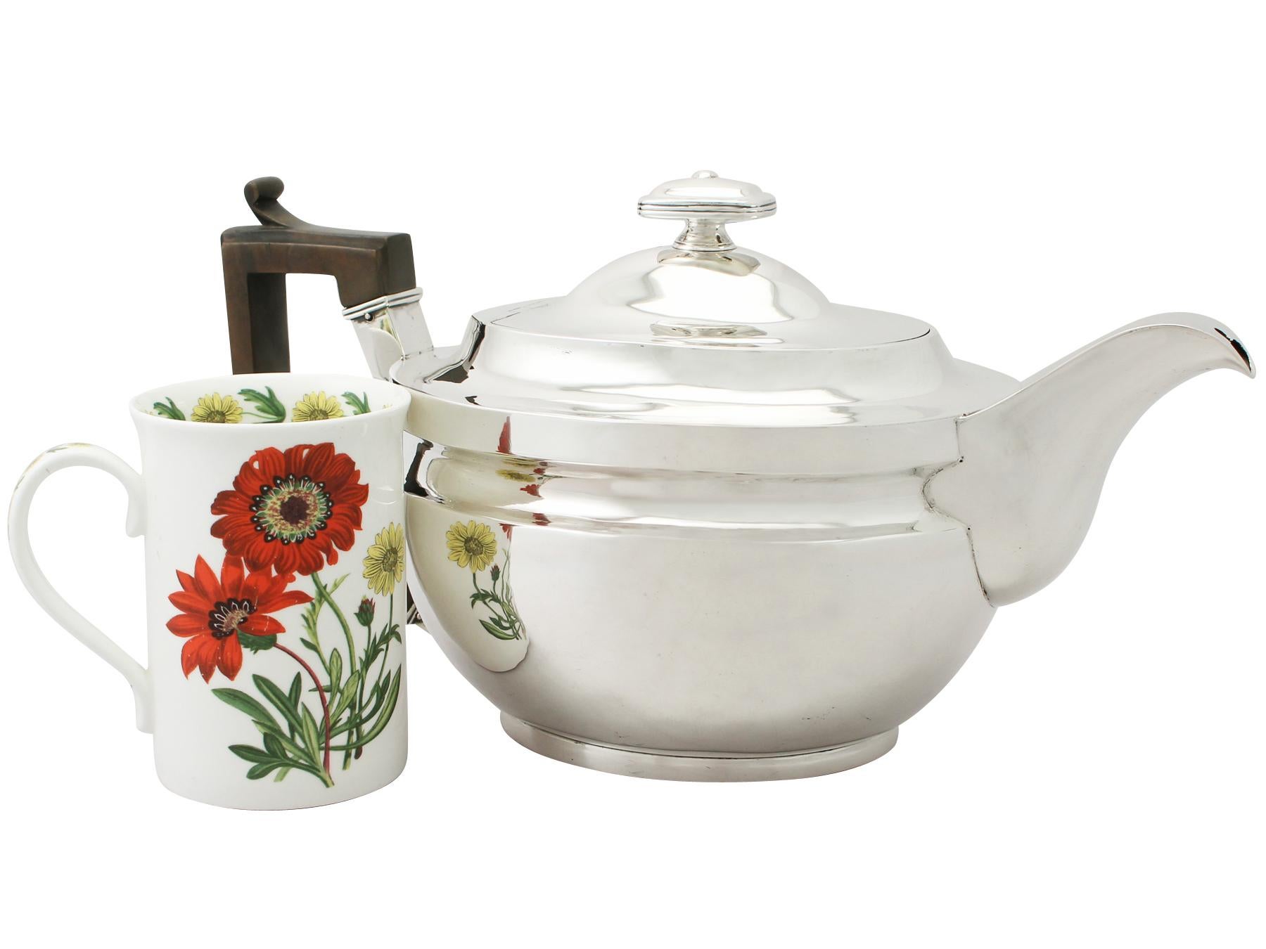 An exceptional, fine and impressive, large antique George III English sterling silver teapot; an addition to our Georgian silver teaware collection.

This exceptional antique George III sterling silver teapot has a plain oval rounded form onto a
