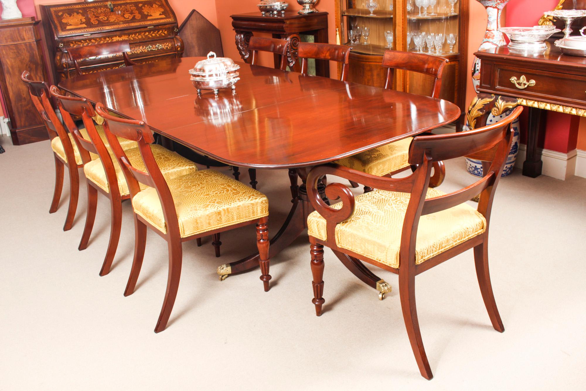 This is an elegant dining set comprising an antique George III dining table, Circa 1780 in date, with a fabulous set of eight mahogany George III barback dining chairs, circa 1830 in date

The table is raised on twin bases each with turned pillars