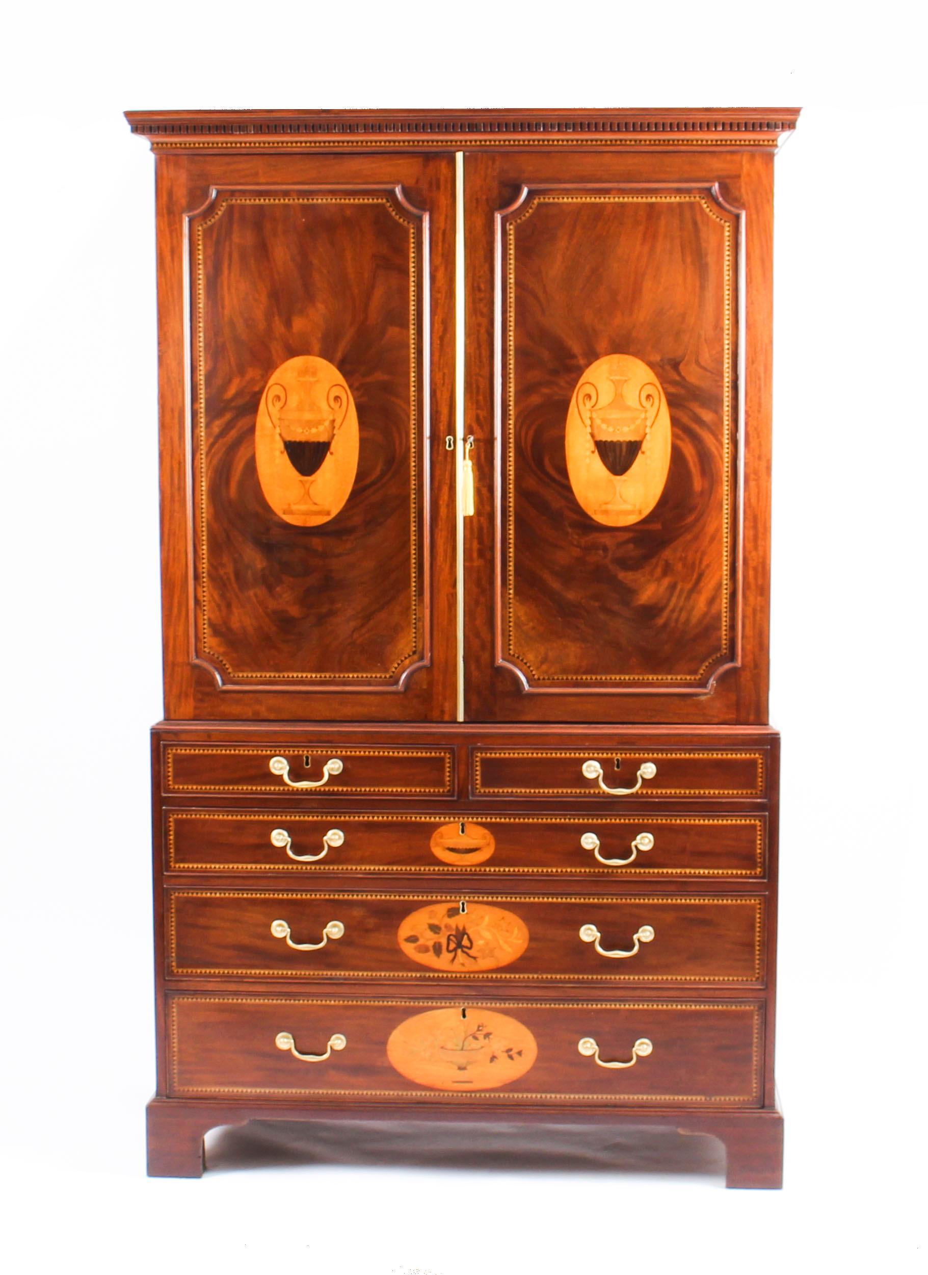 This is a spectacular antique George III flame mahogany and satinwood marquetry linen press, circa 1780 in date.
 
This splendid linen press features an exquisite dentil cornice above a gorgeous pair of cupboard doors that have been masterfully