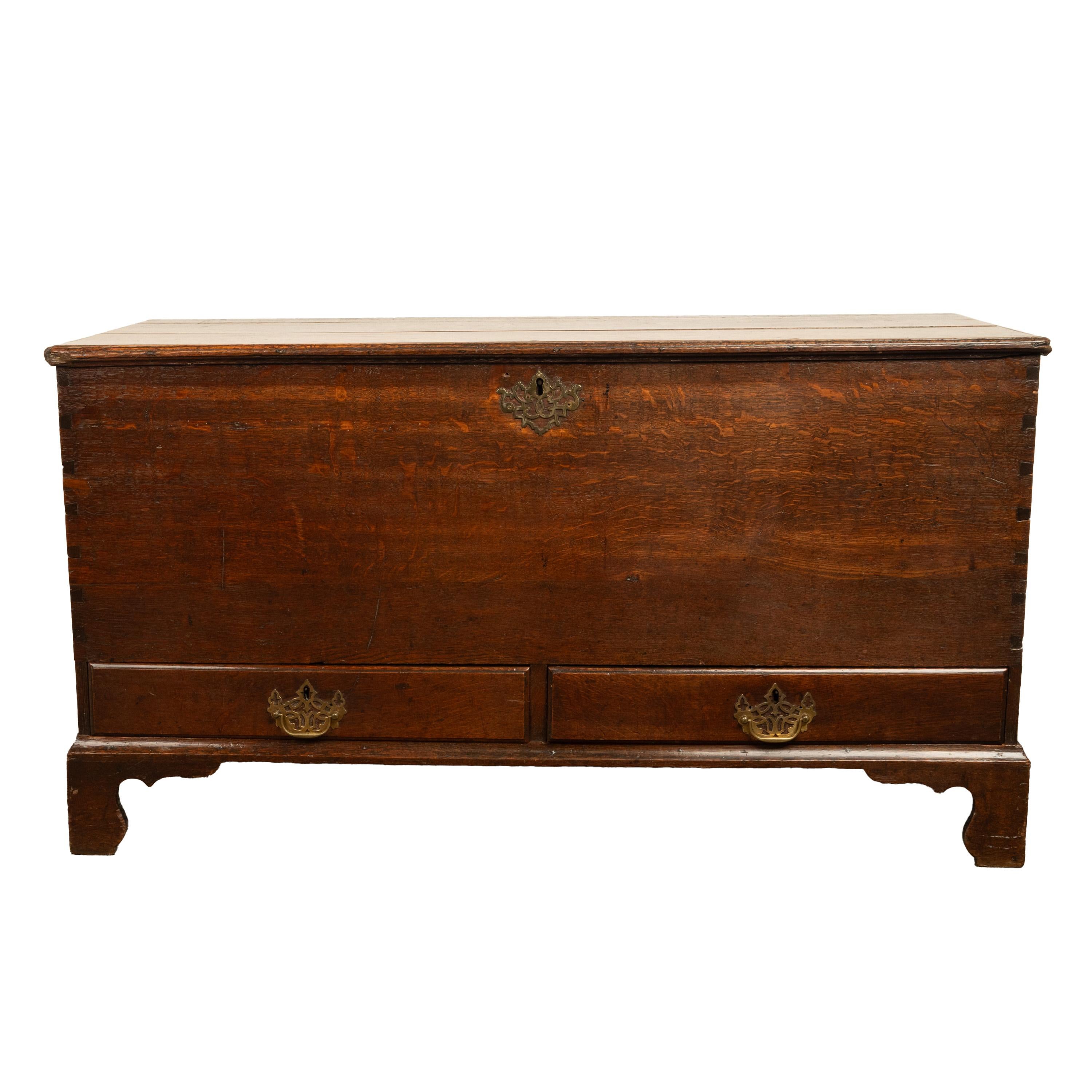 A good George III country oak mule chest, coffer, circa 1760.
The lift up oak lid having the original hand-forged strap hinges and encloses a large storage area for bedding, clothes or? The chest with the original pierced brass lock plate, a key is