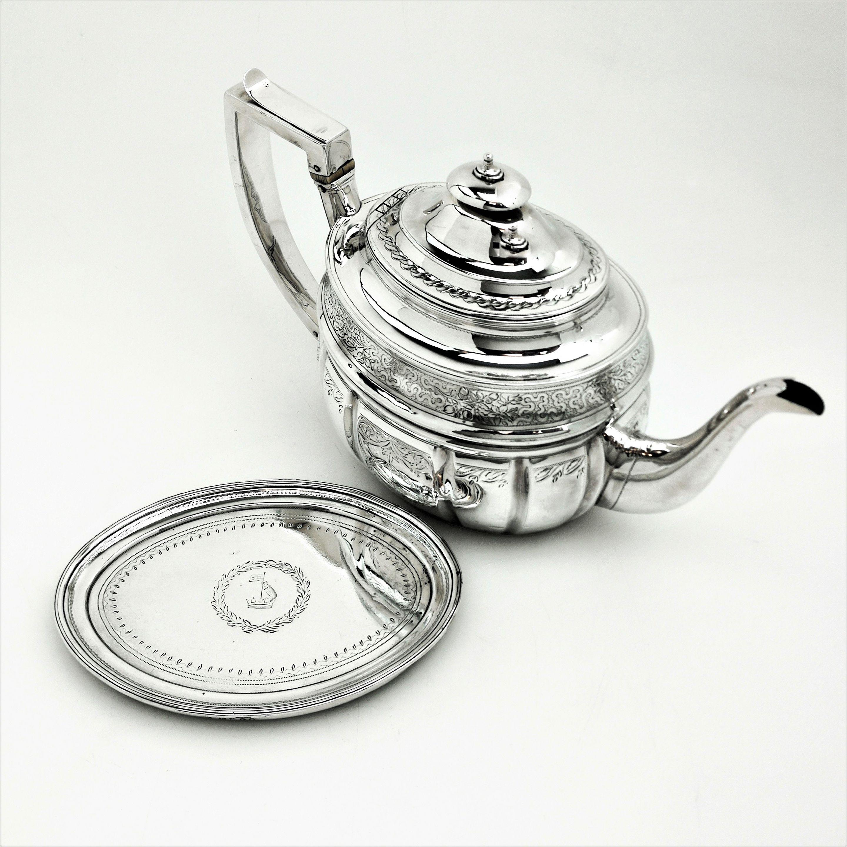 An Antique George III solid Silver Teapot on Stand decorated with a delicate engraved design on the Teapot and on the Oval Tray below. The Teapot and Tray both have matched crests engraved.
 
 Made in London in 1804 by Crespin Fuller.
 
 Approx.