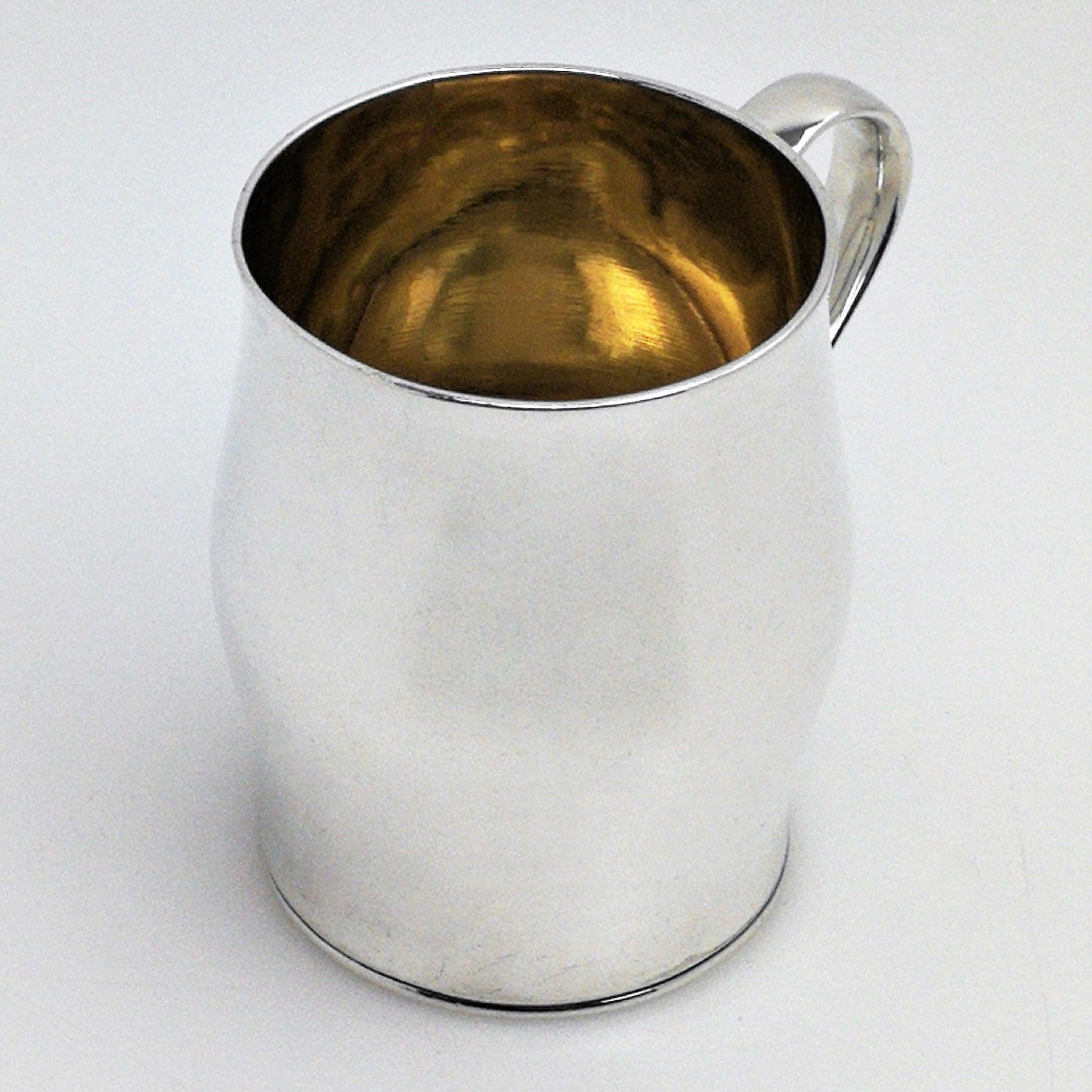 A lovely antique George III solid silver christening mug with a plain bellied form. The mug is of good weight and has elegant proportions. It has a polished exterior, gilded interior and nice scroll handle.
 
 Made in Chester in 1765 by Richard