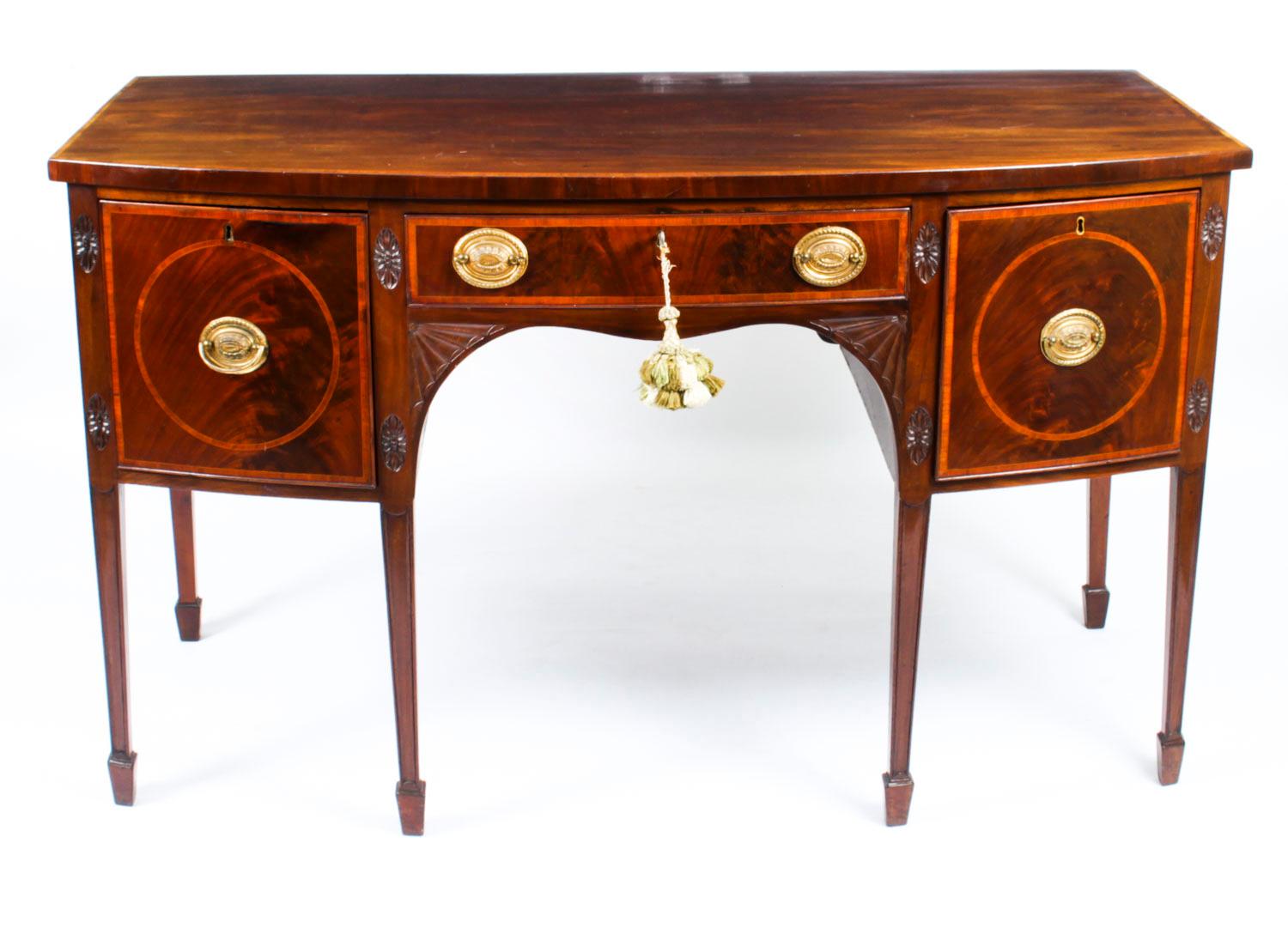 This is a superb antique George III inlaid flame mahogany bowfront sideboard, circa 1780 in date.

The top is banded in satinwood and the sideboard has three oak lined frieze drawers decorated with satinwood banding and oval brass handles.

It is