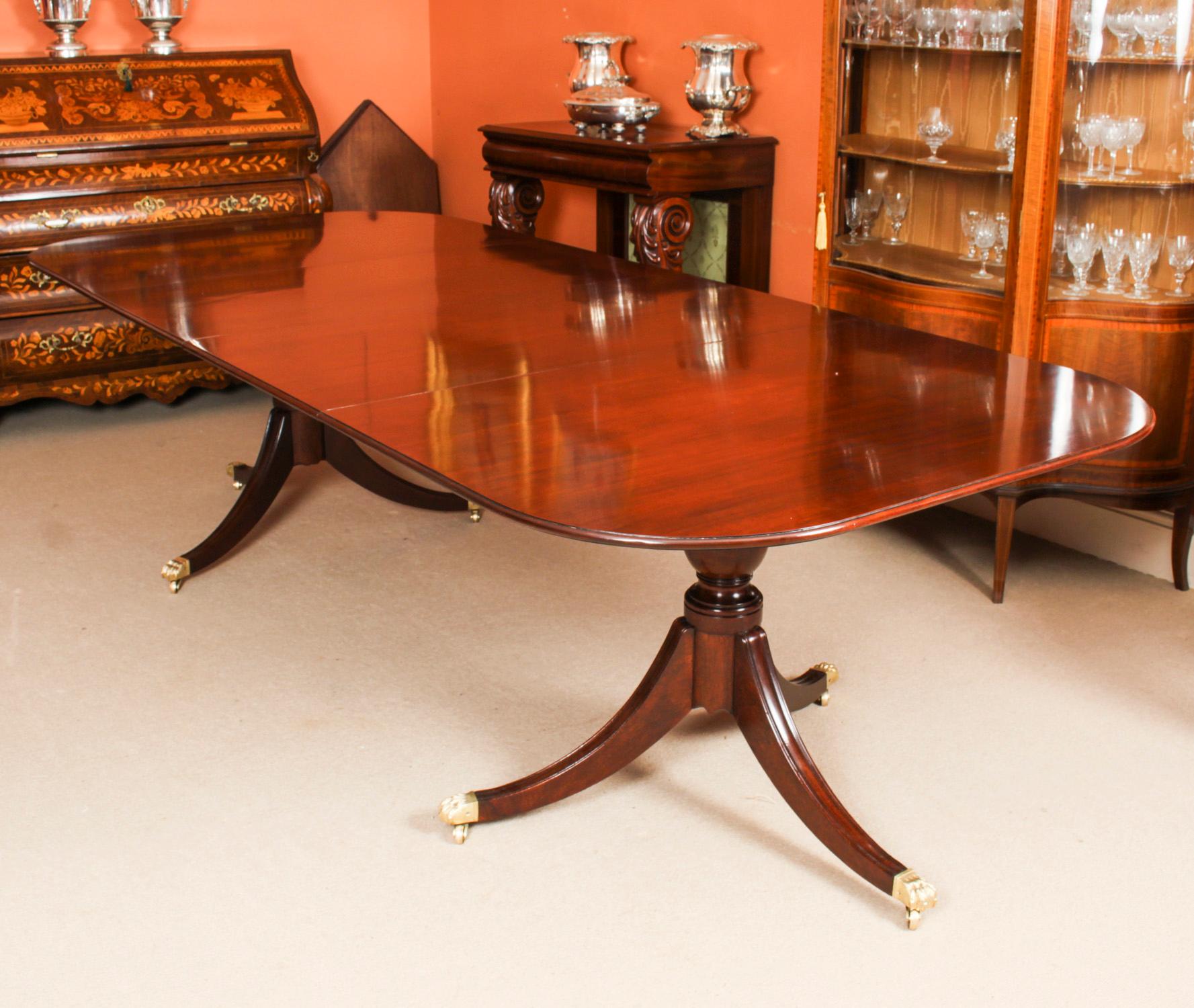 This is an elegant antique period George III dining table, Circa 1780 in date.

The table is raised on twin bases each with turned pillars on reeded sabre legs terminating in brass Lion's paw caps and castors. It has two leaves which can be added