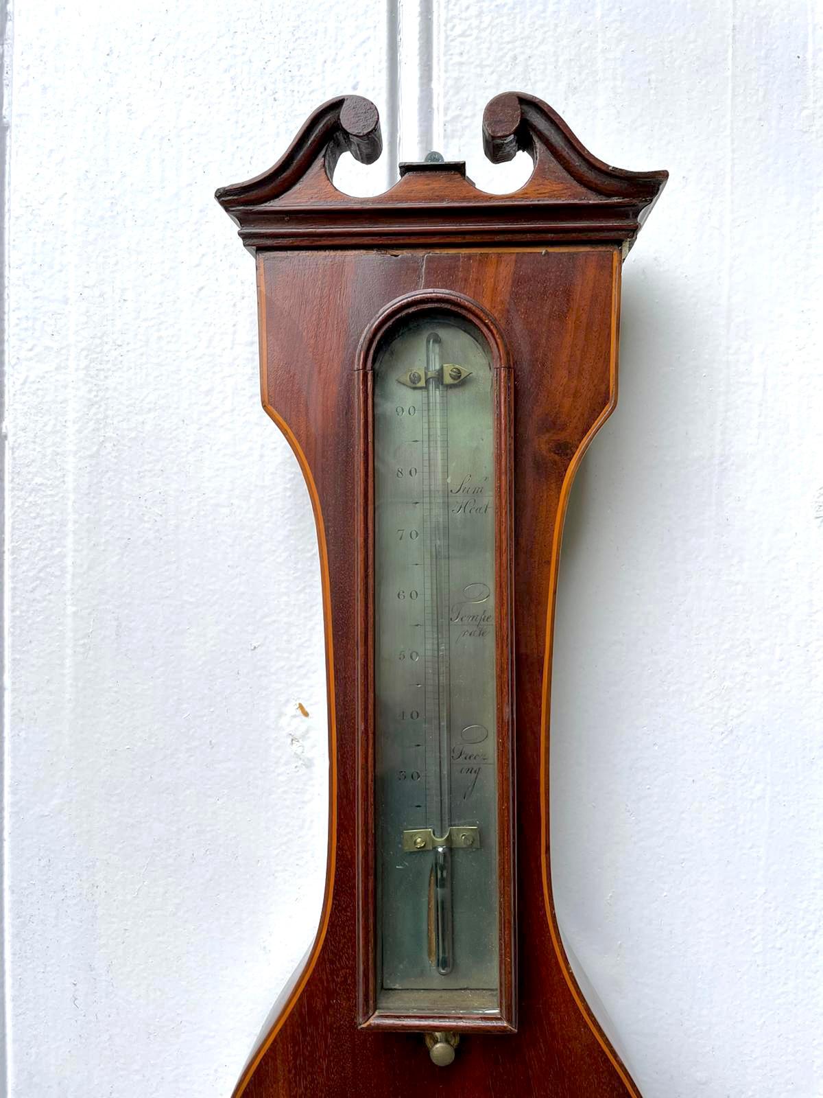 Antique George III mahogany and boxwood inlaid banjo barometer having a quality swan neck pediment, 10 inch silvered engraved dial with hygrometer, thermometer and spirit level, original brass bezel and hands. Signed C Marinone.

In perfect
