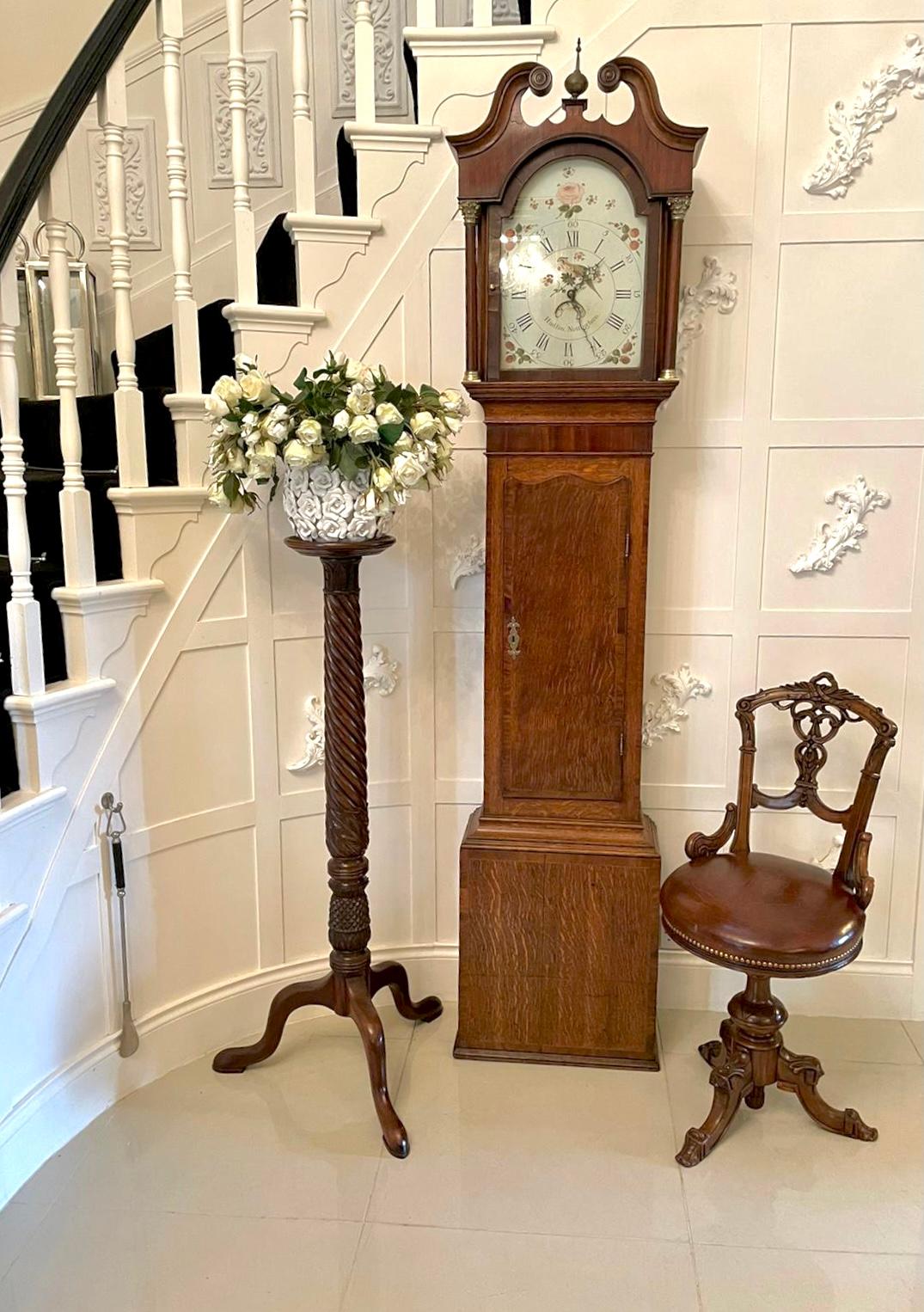 Antique George III mahogany and oak longcase clock by Hudfon of Nottingham having a quality inlaid swan neck pediment and central brass finial above an arched glazed door flanked by turned columns with ornate brass mounts. The arched dial is painted