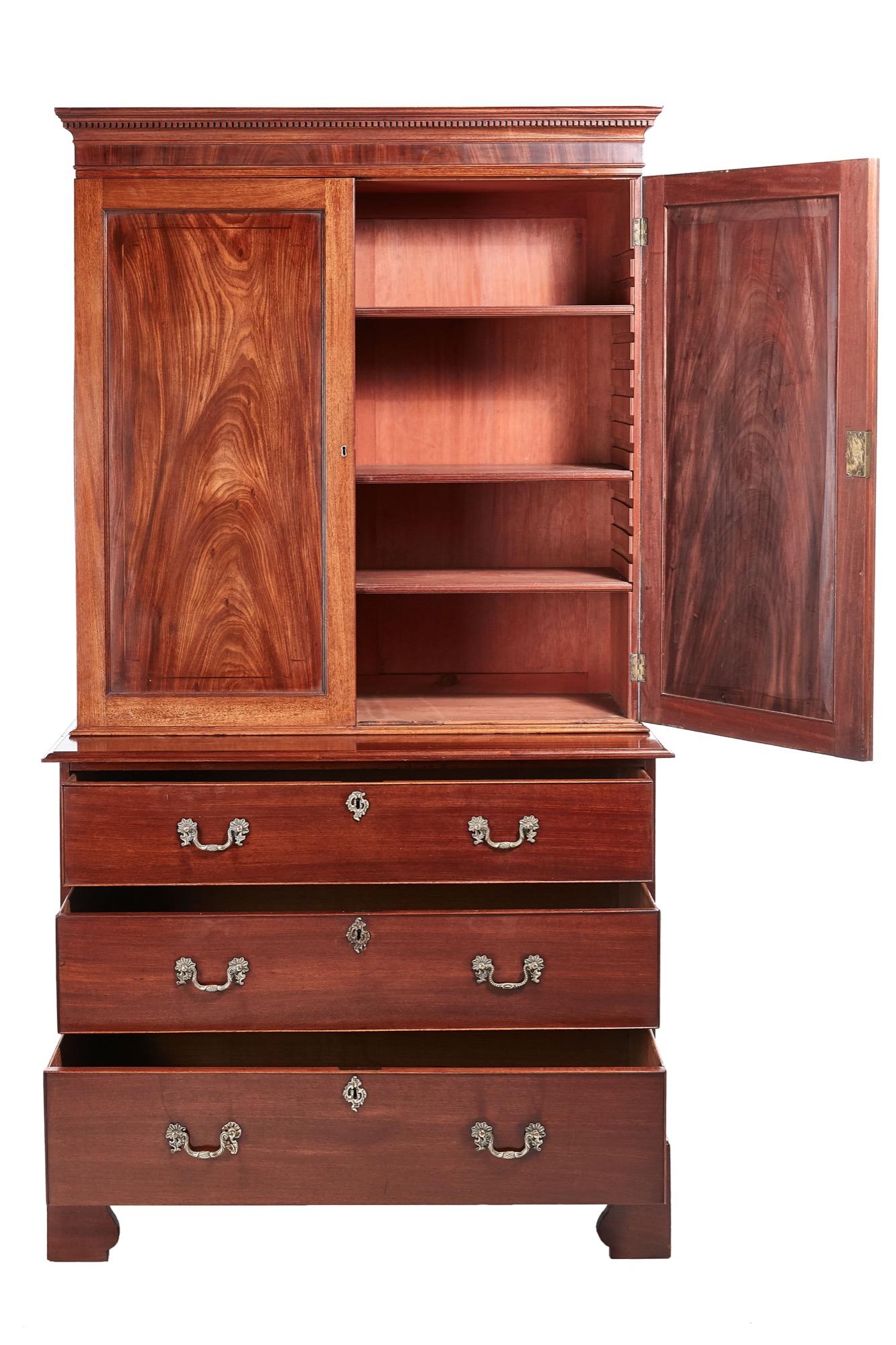 Antique George III mahogany blind door bookcase on chest. The top section with a dentil cornice and a crossbanded frieze, two fantastic mahogany paneled doors containing three adjustable shelves. The base has three long cockbeaded drawers with