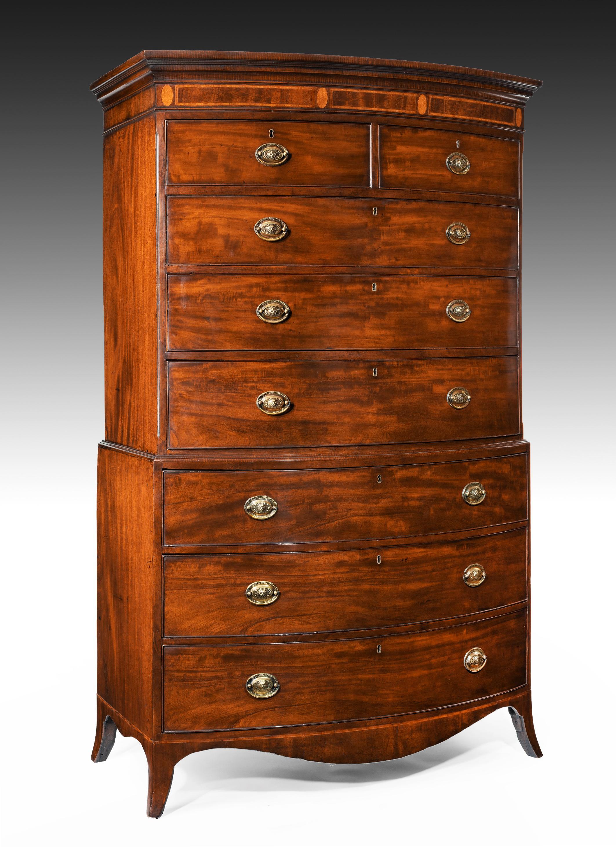 A good quality antique George III period figured mahogany bow fronted tallboy / chest on chest.

English circa 1790.

The fiddle back mahogany timbered bow cornice having a moulded edge over a boxwood strung and satinwood inlaid frieze,