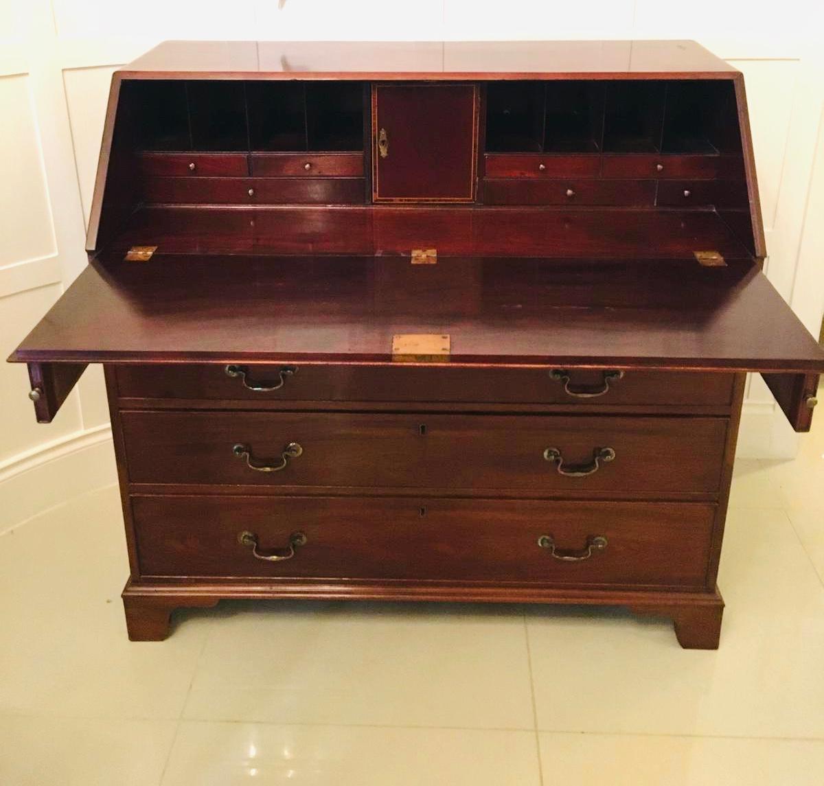 This is an outstanding quality antique 18th century George III mahogany bureau having a quality mahogany fall which opens to reveal a fully fitted interior consisting of seven drawers all with original brass knobs, pigeon holes and a pretty inlaid