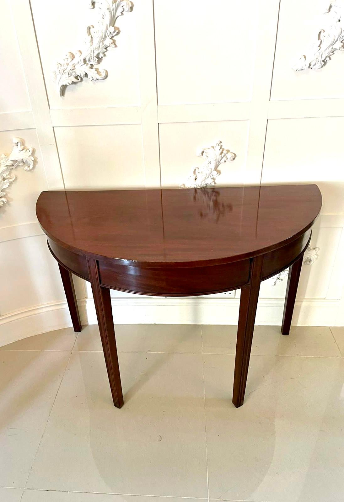 Antique George III mahogany demi-lune console table having a quality mahogany top, mahogany frieze with a moulded edge and standing on elegant square tapering reeded legs.

In very desirable original condition with an attractive colour and