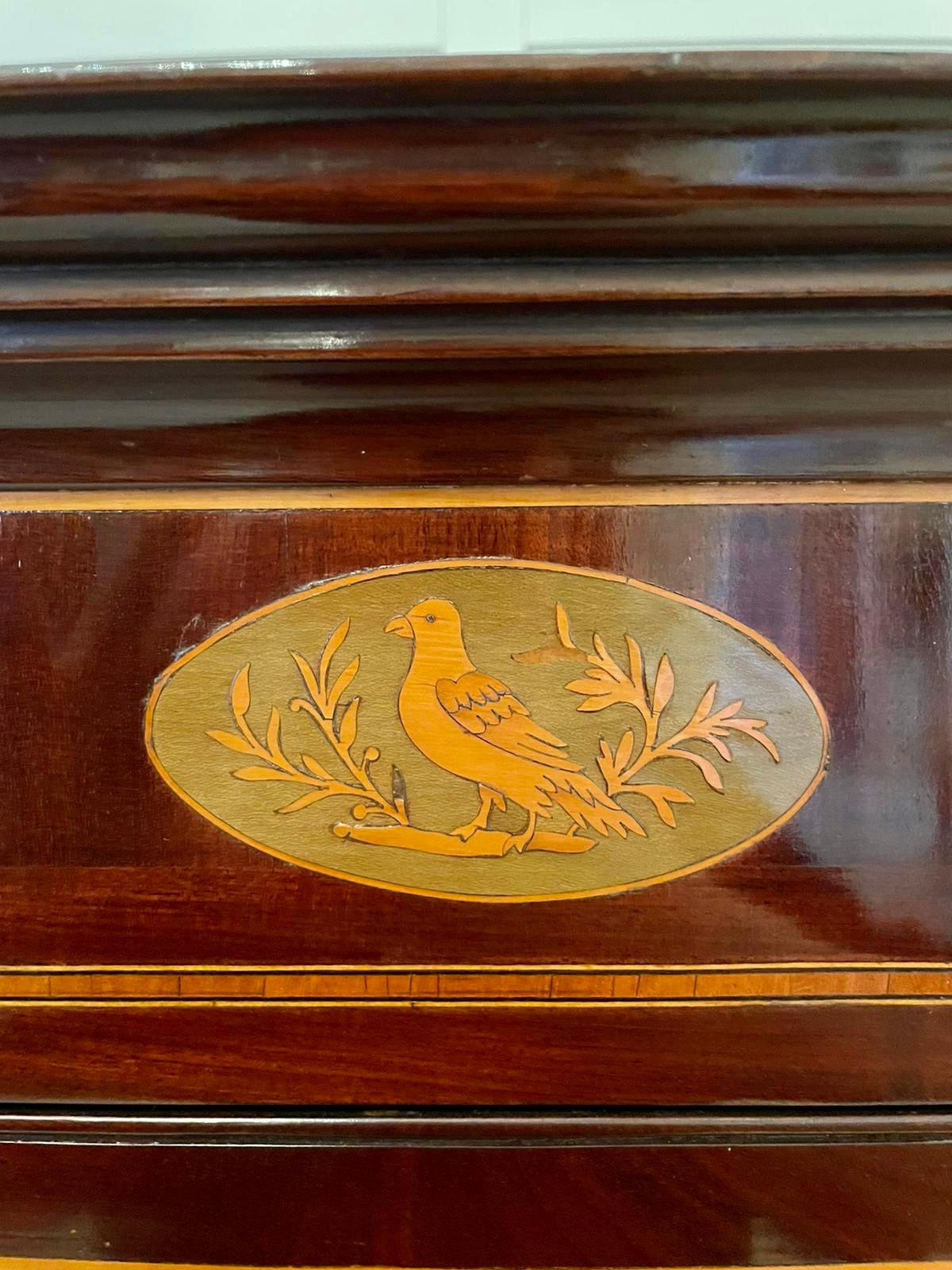 Antique George III mahogany inlaid straight front hanging corner cupboard having a moulded cornice and quality inlay to the frieze depicting a bird and foliage, pretty satinwood inlay stringing to the sides. The quality astragal glazed door opens to