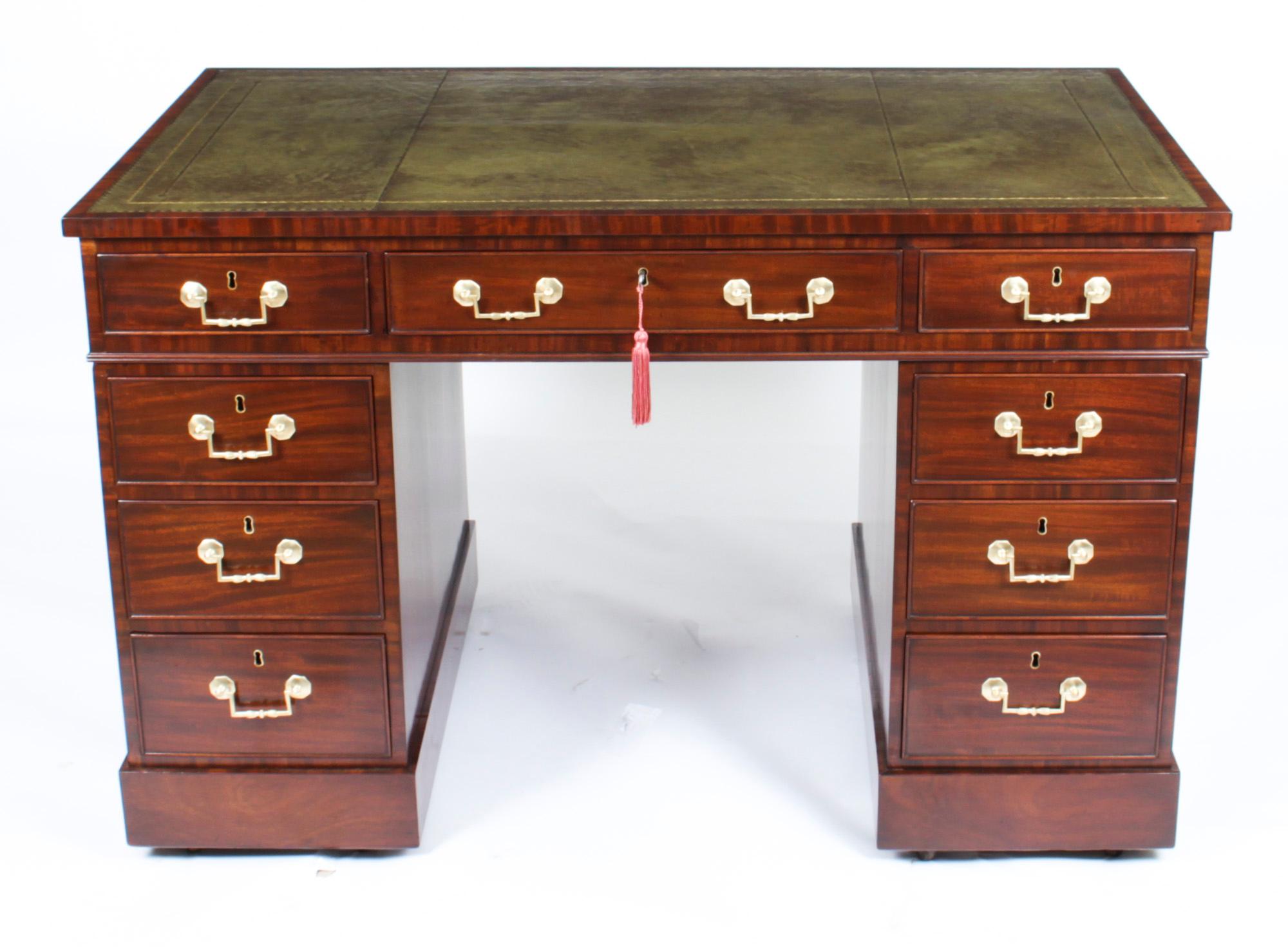 This is a superb antique George III mahogany pedestal desk, dating from Circa 1790.
 
The rectangular top features an inset green and gilt tooled leather writing surface above three frieze drawers with a further three drawers in each pedestal to one