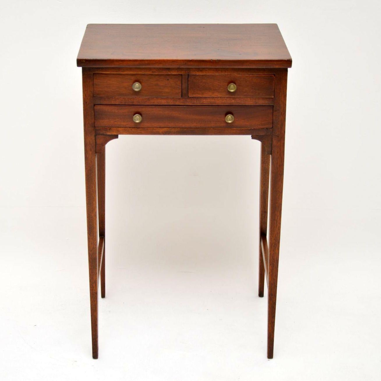 Small elegant George III mahogany side table with three drawers, brass handles and sitting on tapered legs with cross stretchers. It’s in good condition, with no splits or warps and I would date it to circa 1790s period.

Measures: Width – 18