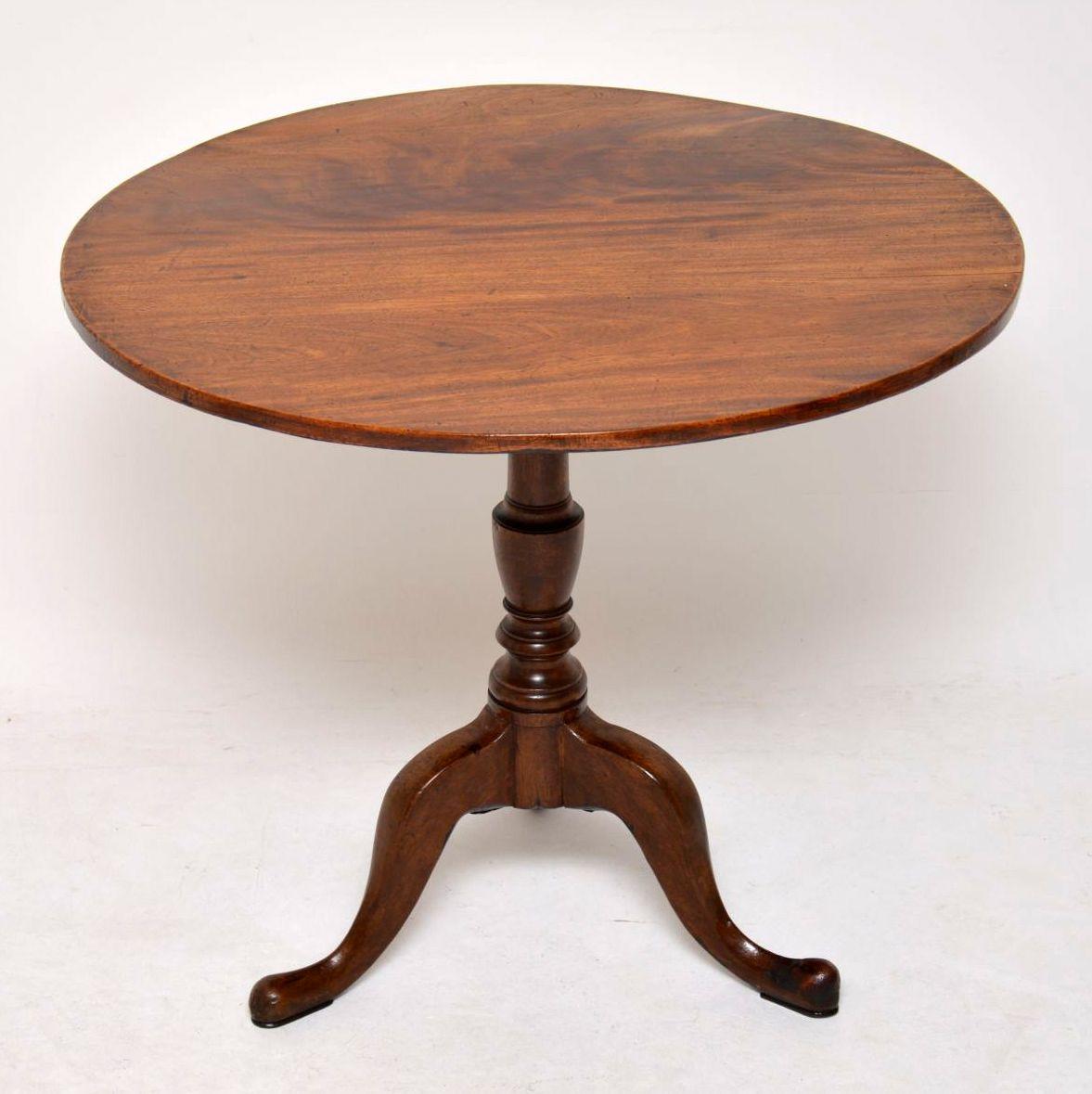 Antique George III solid mahogany tilt-top table in very good original condition. It has a circular top sitting on a turned base with tripod pad feet. The grain of the mahogany on the top is beautiful & it has a wonderful original patina. This table