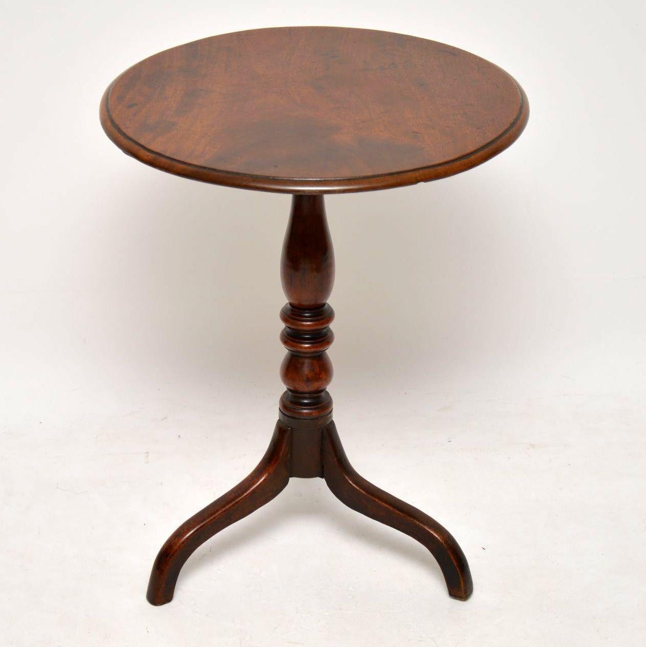 Antique period George III mahogany wine table in good condition and with a wonderful original color and patina. The circular top sits on a well turned pedestal with tripod legs. I would date this table to circa 1790-1800s period.

Measures: Width