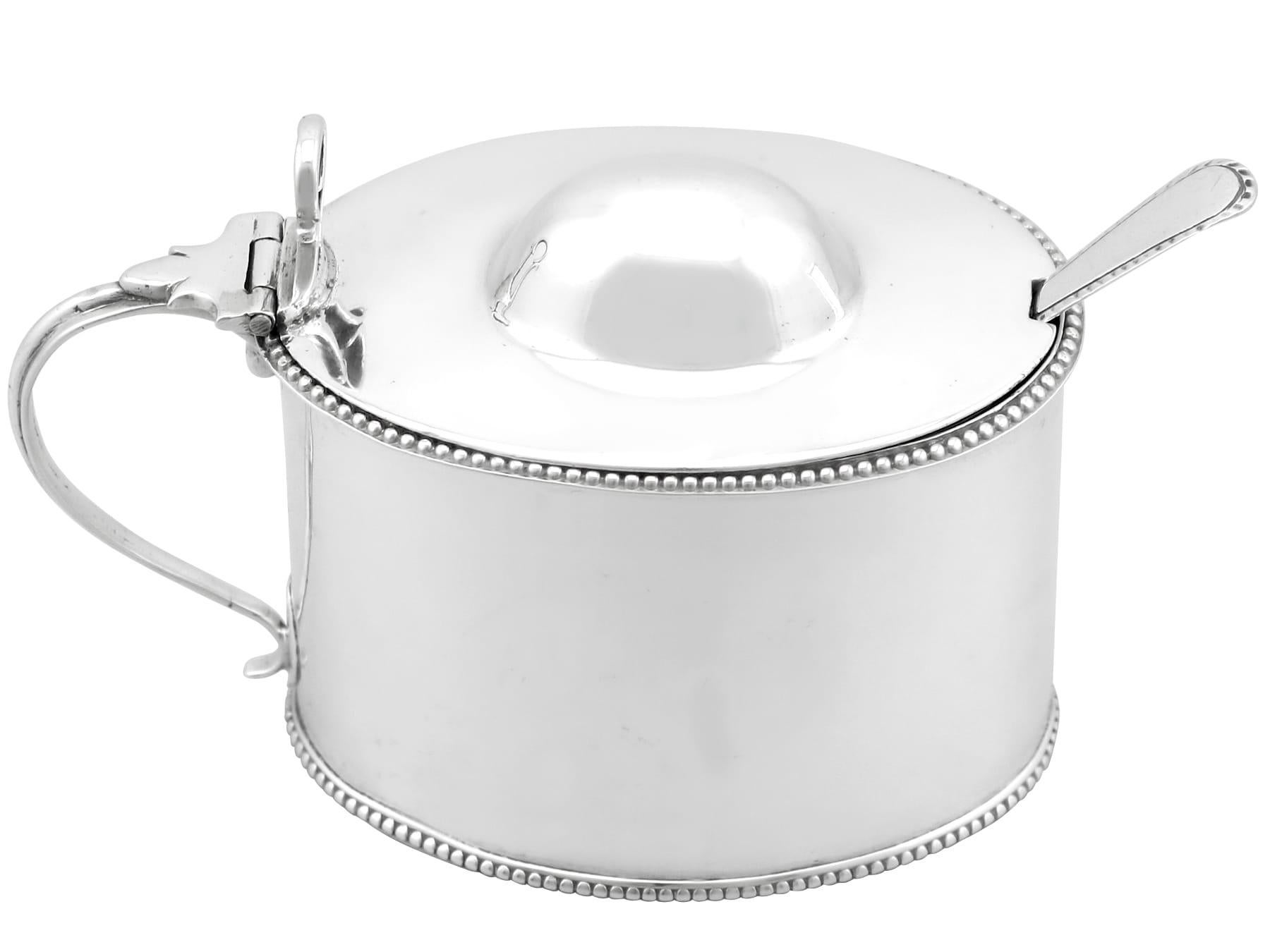 A exceptional, fine and impressive, large antique George III Newcastle sterling silver mustard pot; an addition to our Georgian silver cruets / condiments collection.

This exceptional antique George III sterling silver mustard pot has a plain oval