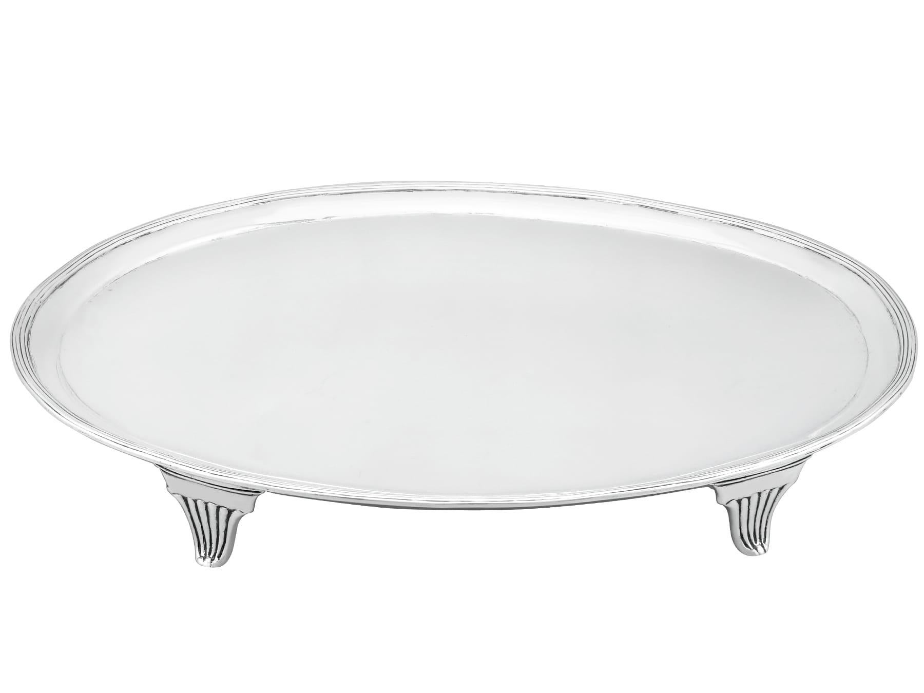 An exceptional, fine and impressive antique Georgian Newcastle English sterling silver salver; part of our antique George III dining collection.

This exceptional antique George III Newcastle sterling silver salver has a plain oval form onto four